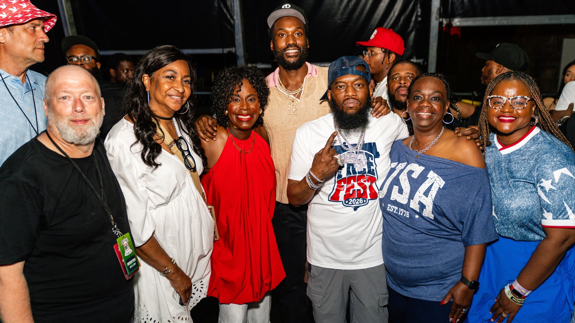 Left to right: ESM Productions co-owner Scott Mirkin, standing backstage with several people, including Mayor Cherelle Parker and rapper Meek Mill. 