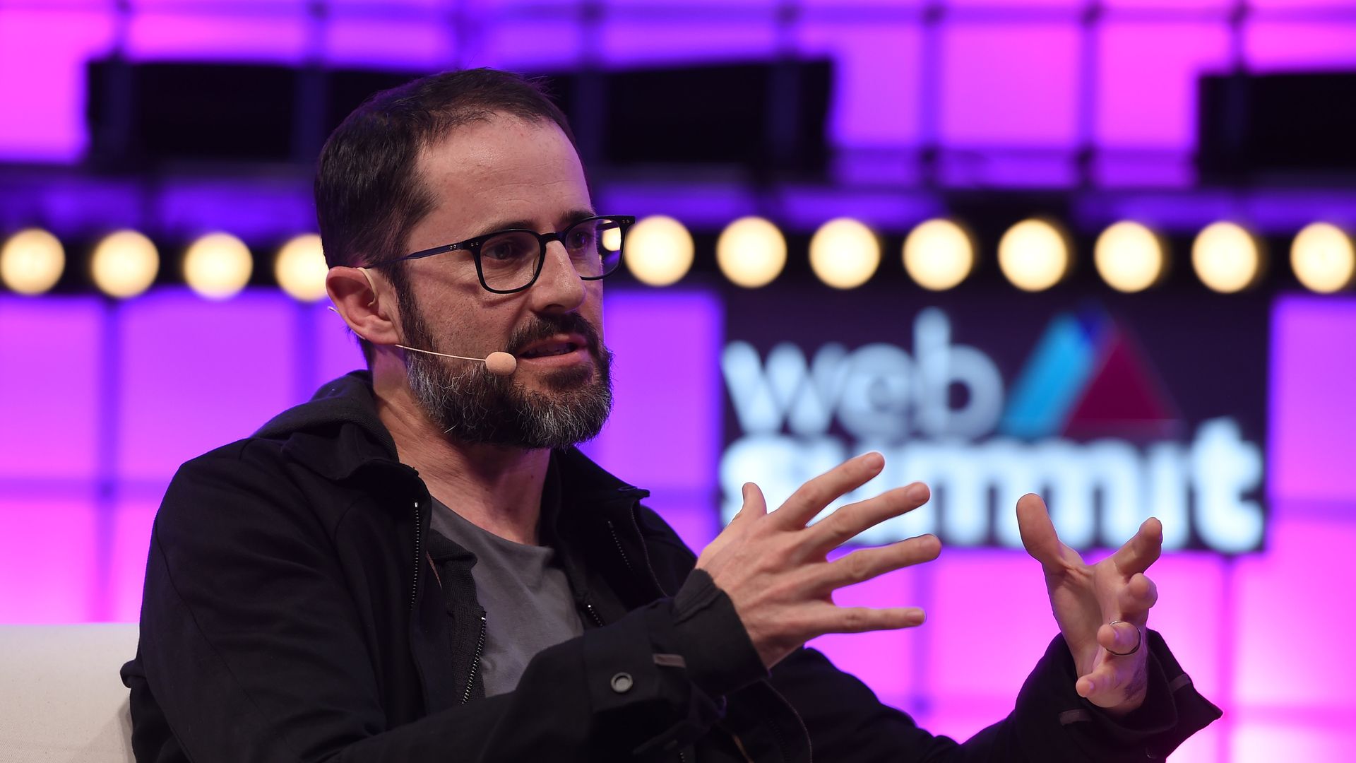 Photo of Twitter co-founder Ev Williams speaking on conference stage.