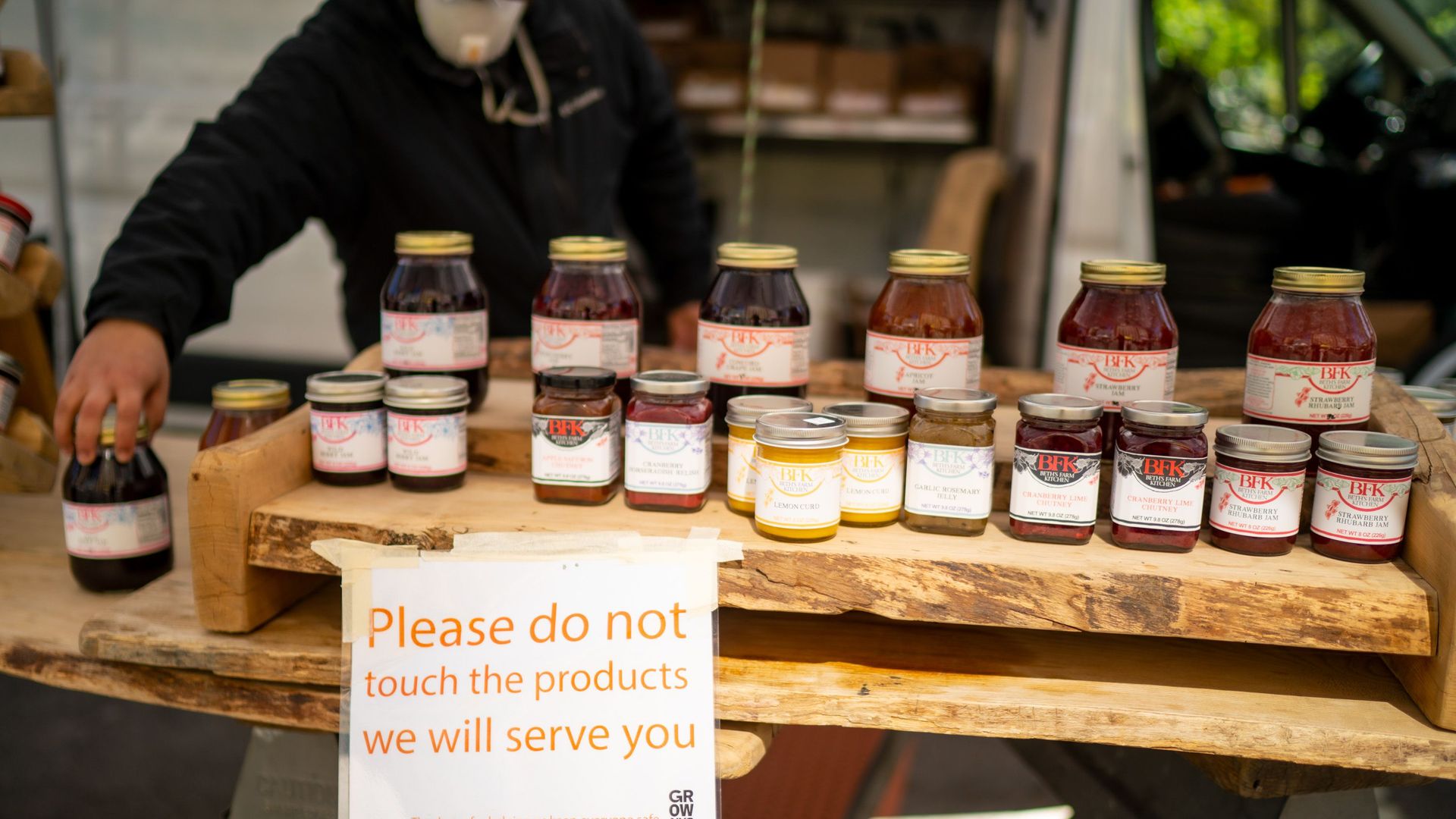 In this image, a sign reads "please do not touch the products we will serve you"