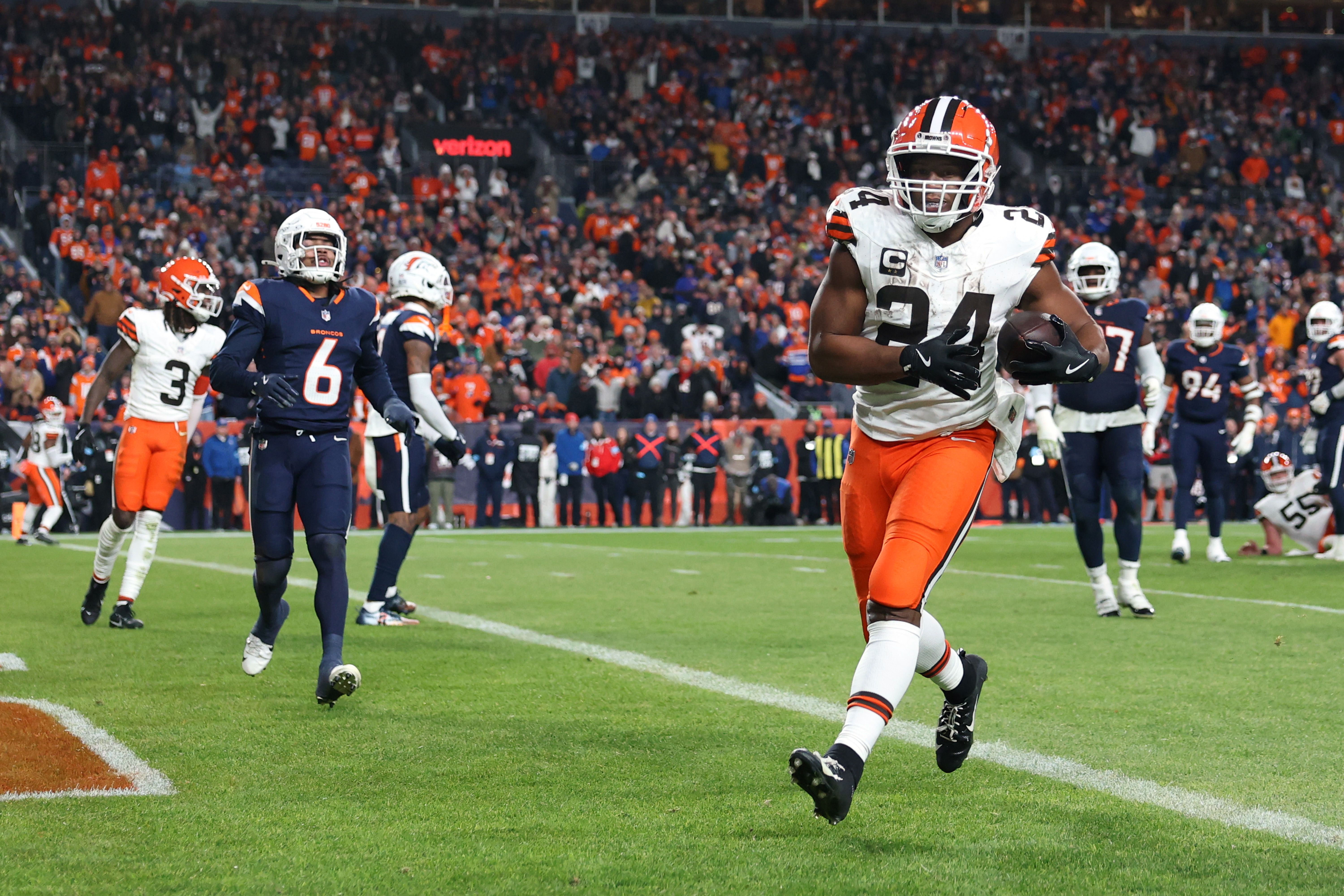 Photo of a football player running across a goal line for a touchdown during a game