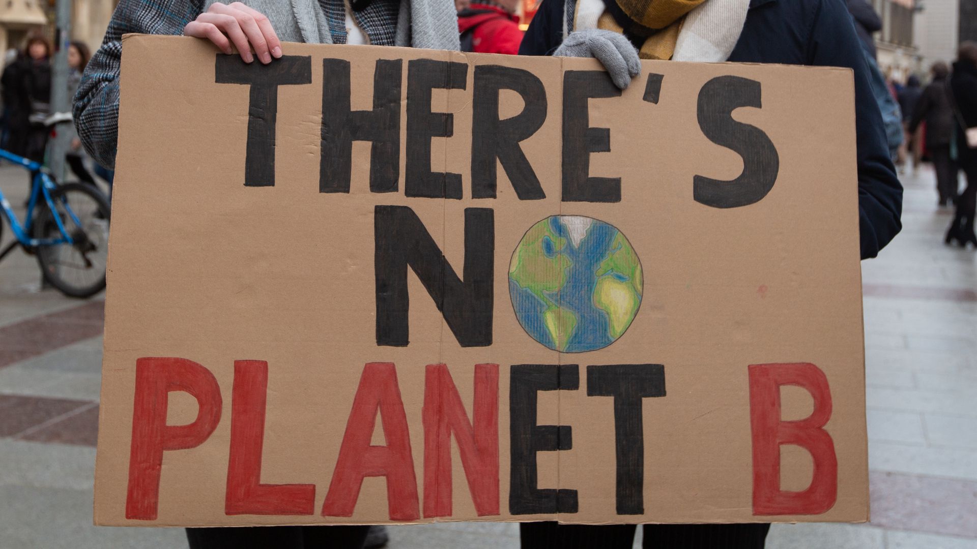Two women holding a sign that says "there's no planet B"