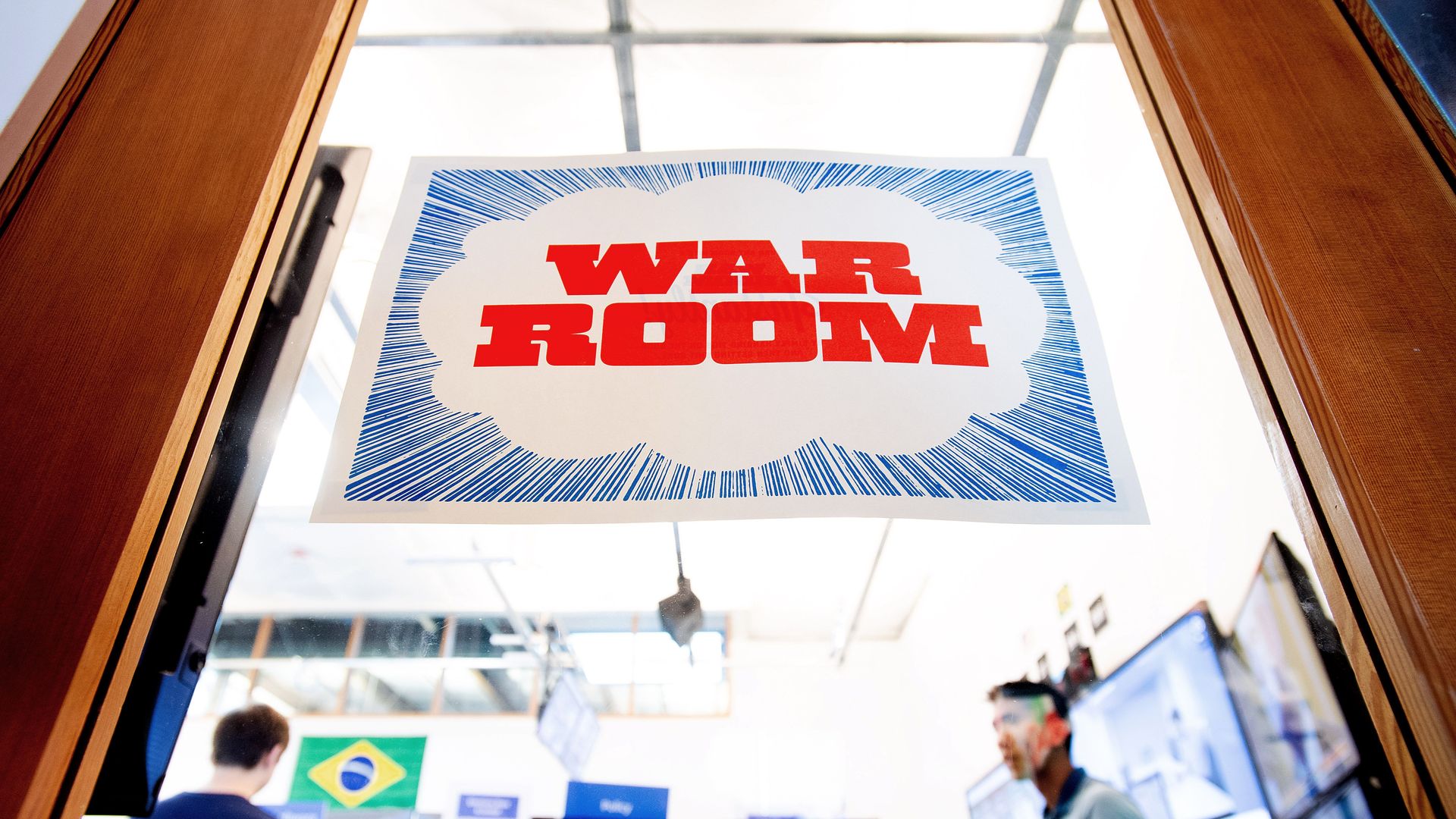 A sign reading "War Room" on a glass door