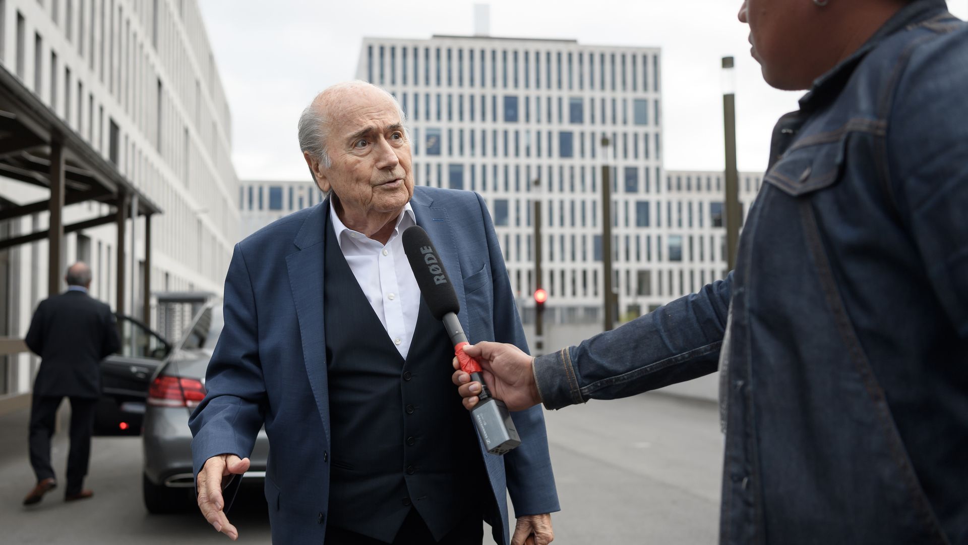 Former FIFA Sepp Blatter speaking to a reporter while arriving to a hearing summoned by Swiss prosecutor in September 2020 in Bern.