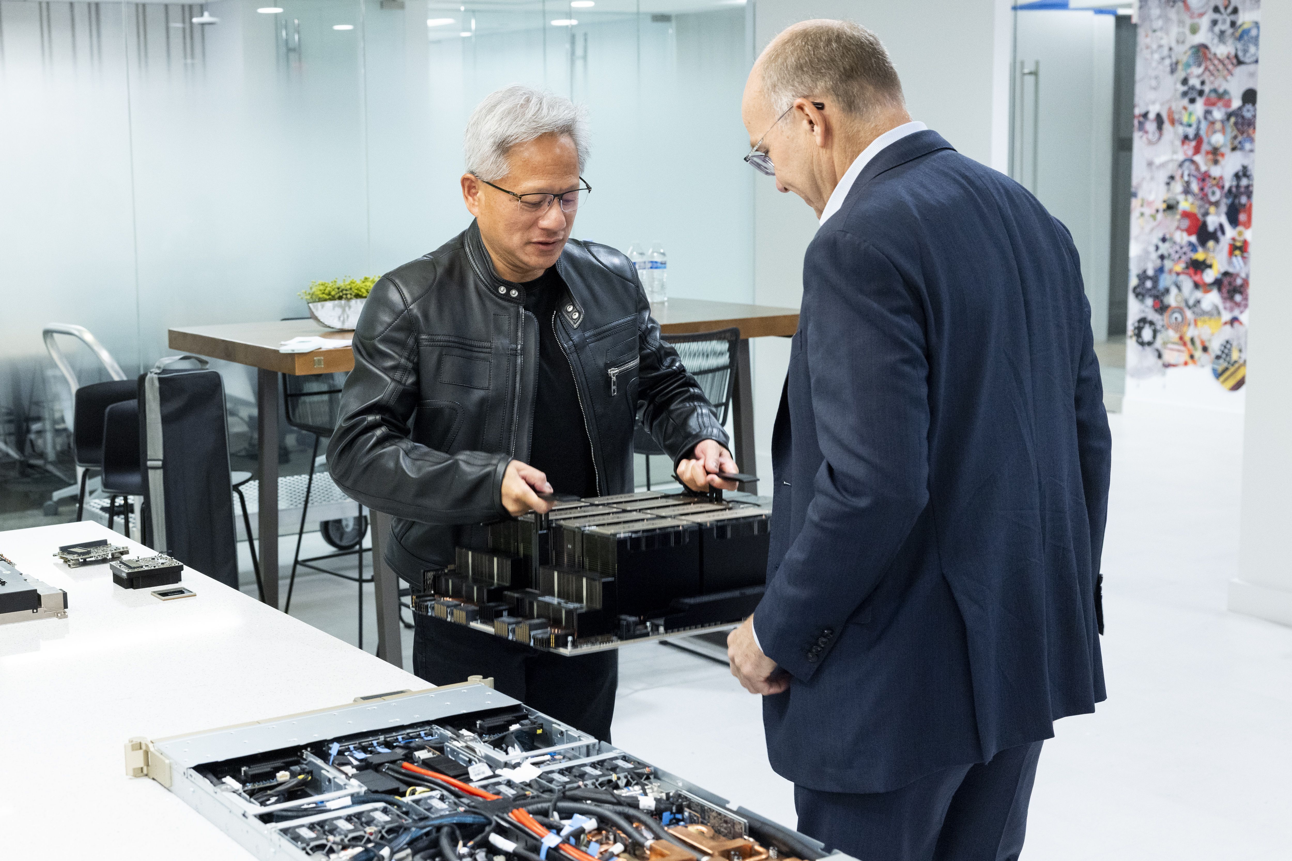 Nvidia CEO Jensen Huang shows a chip for the China market to Mike Allen in Washington on Friday.