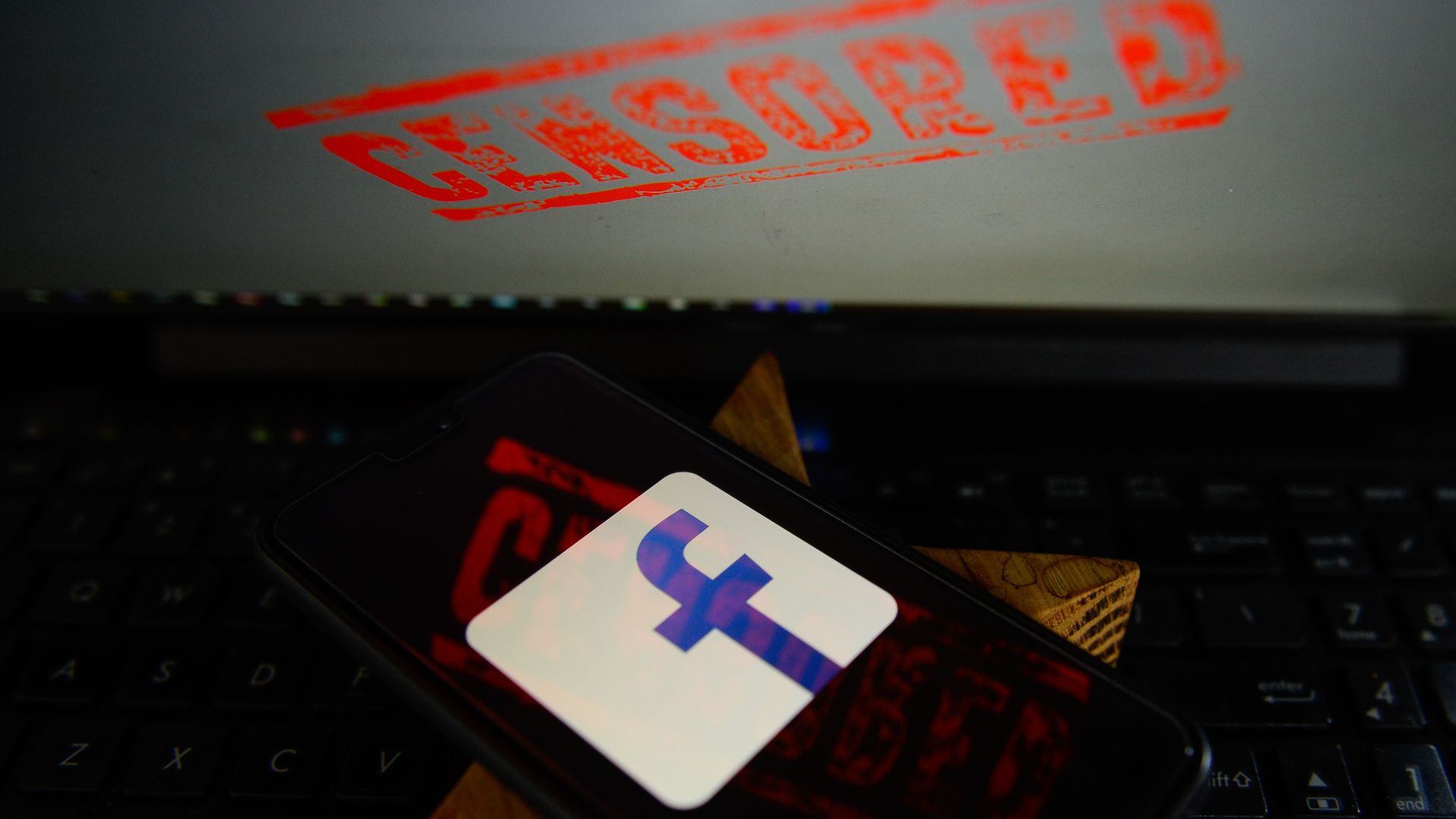 An illustration of "Censored" over the Facebook app