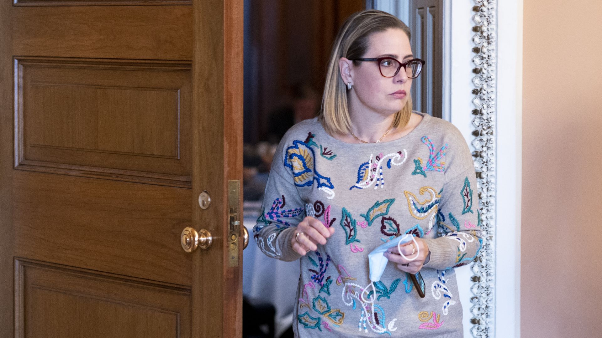 Sen. Kyrsten Sinema is seen leaving the Democratic Policy Luncheon on Tuesday.