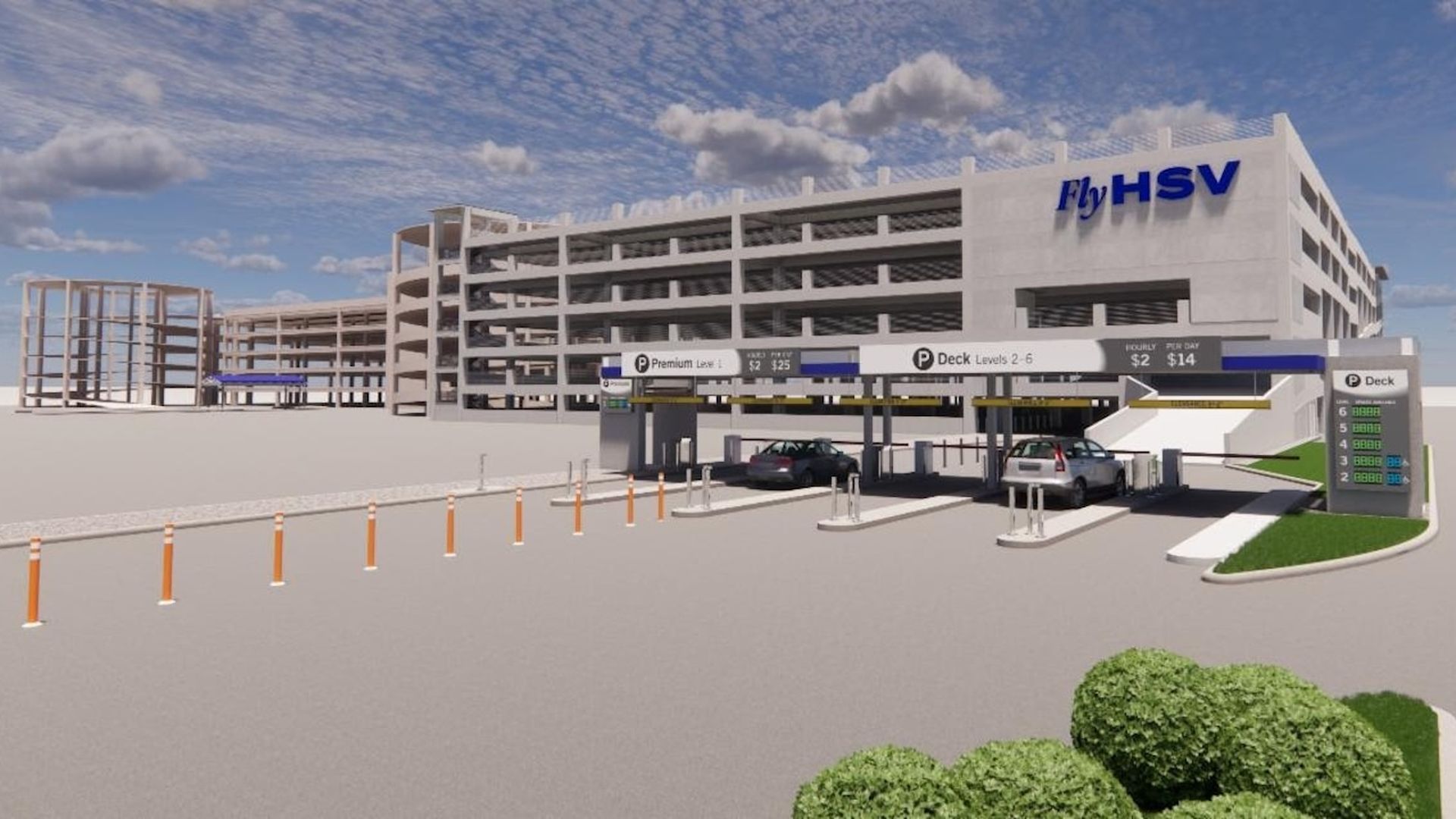 Large multi-level parking garage with "Fly HSV" signage, two cars entering payment lanes, and clear blue sky with scattered clouds. Green bushes in foreground.