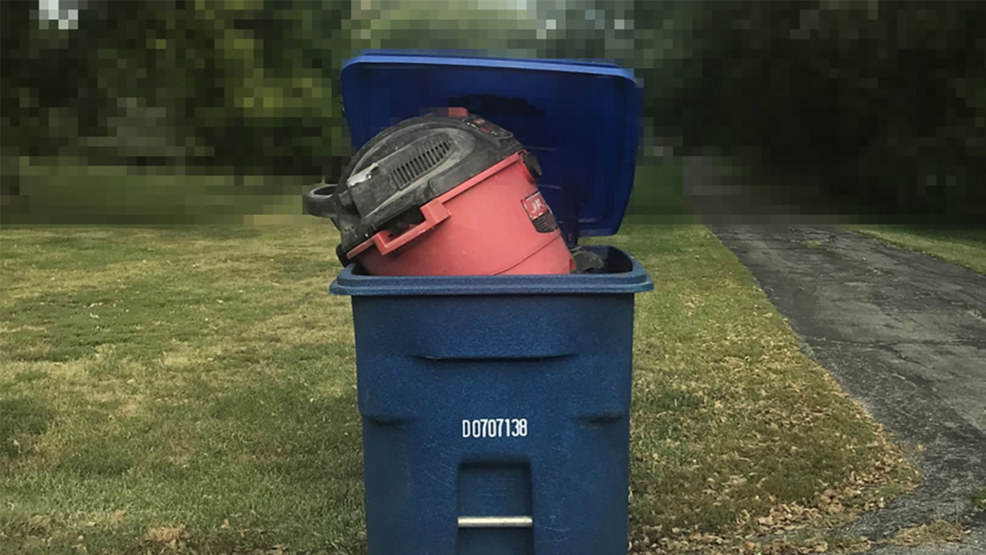 A photo of trash in a recycling totter.