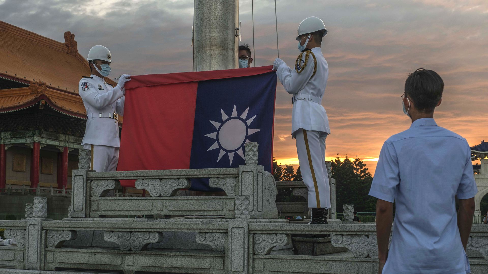 Soldiers lower the Taiwanese flag during a ceremony at the Chiang Kai-shek Memorial Hall in Taipei, Taiwan, in August. Photo: Lam Yik Fei/Bloomberg via Getty Images