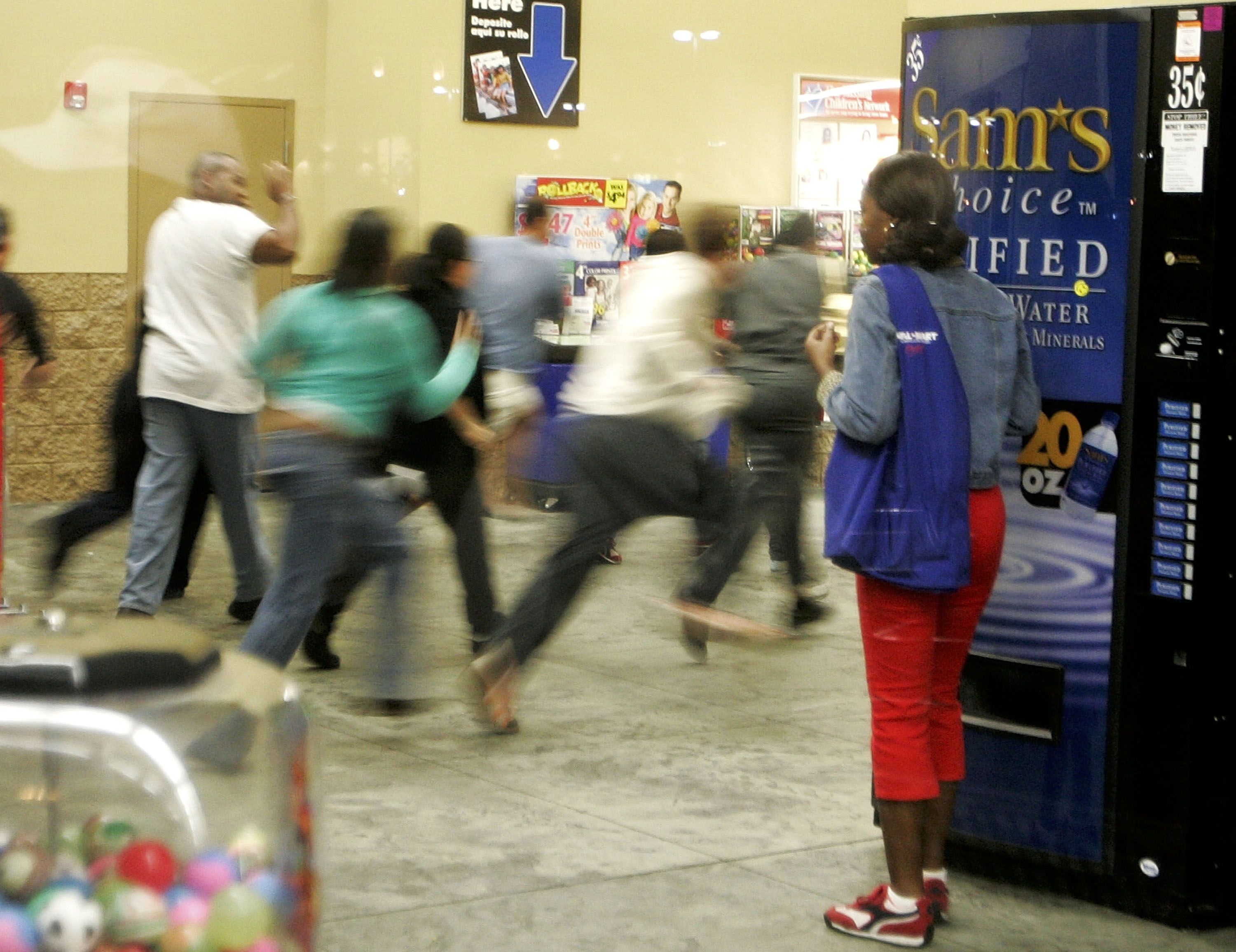 Shoppers running into a WalMart. 