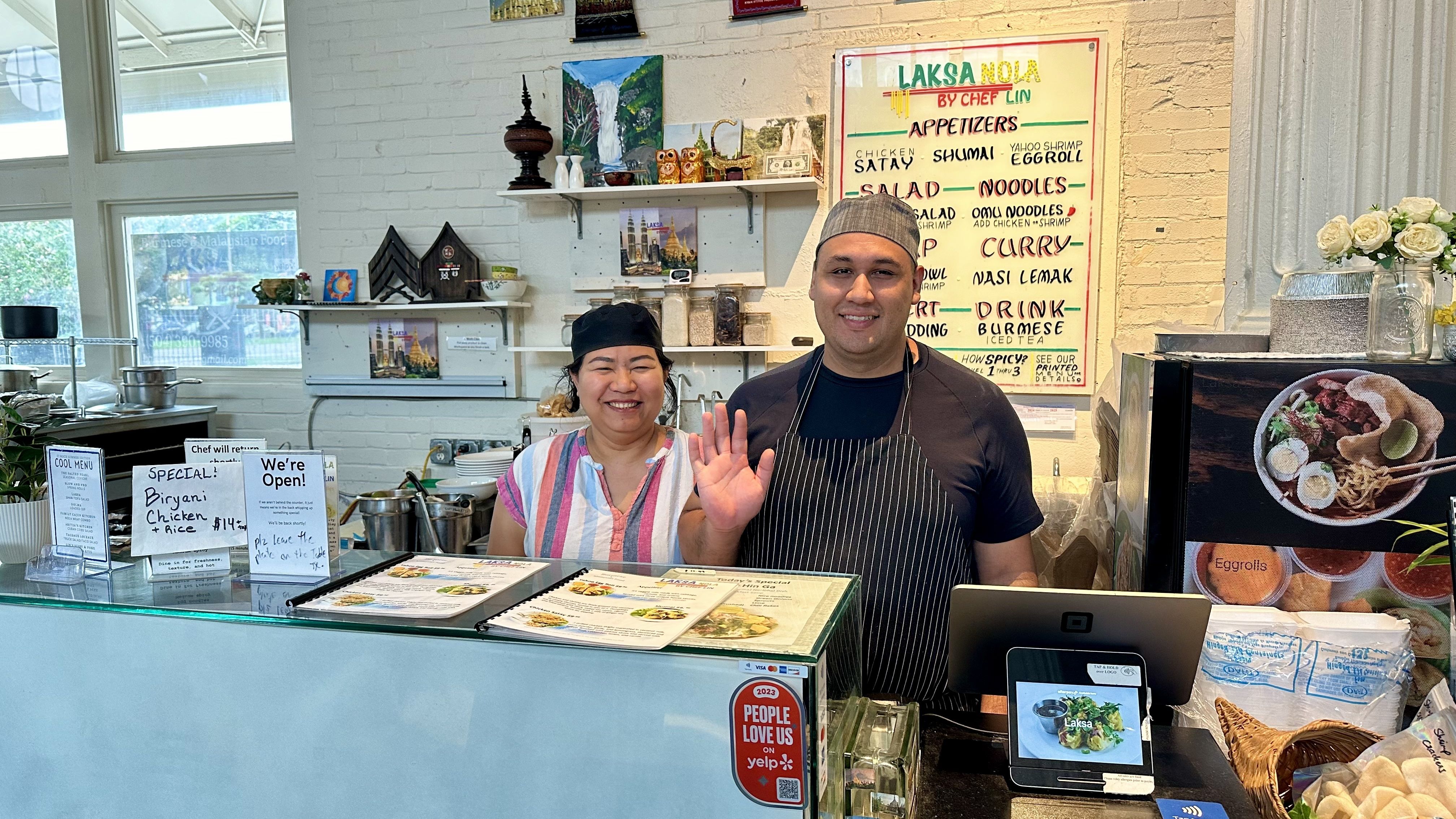 Image shows two chefs behind a counter.
