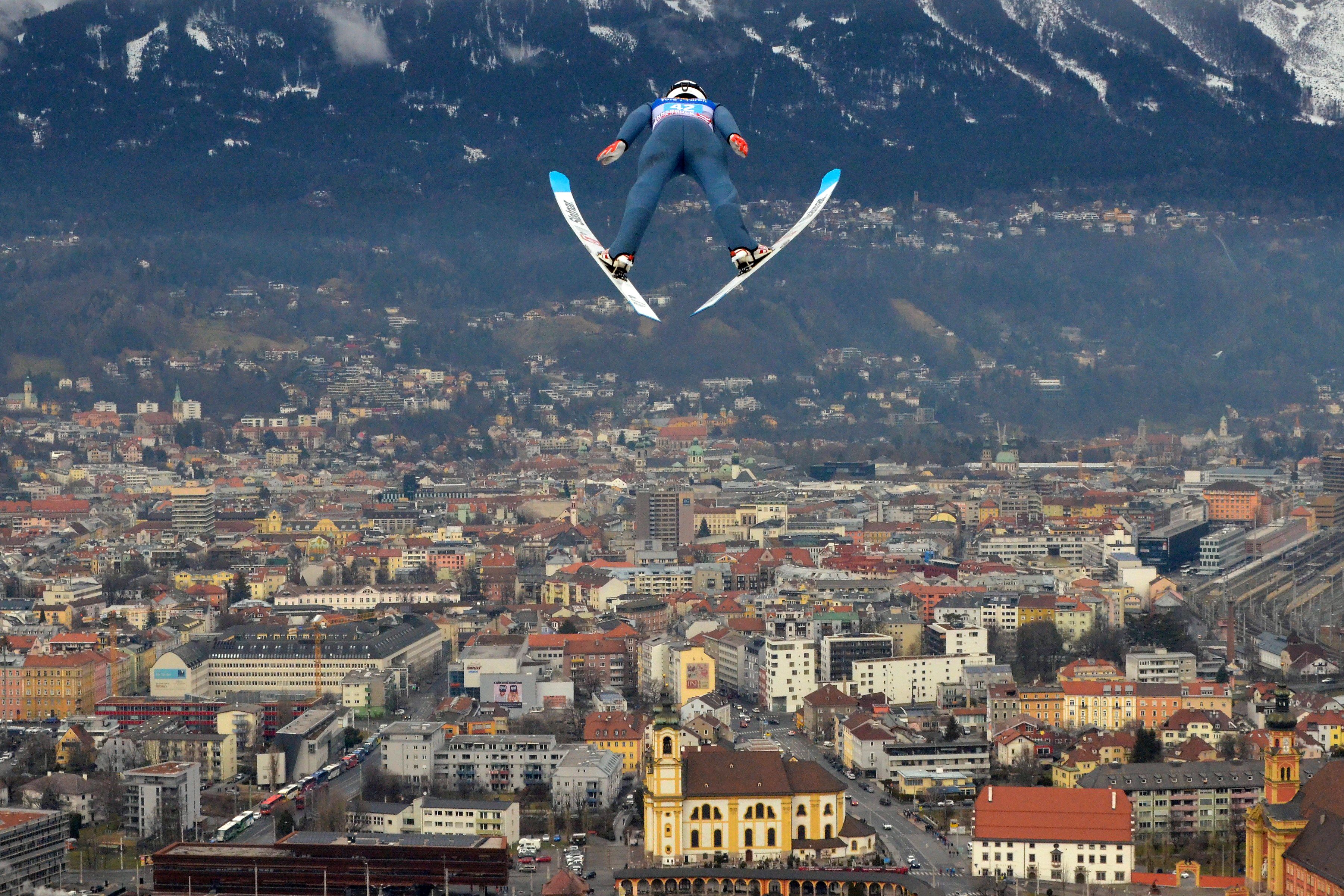 Huge ski jump with city in backdrop