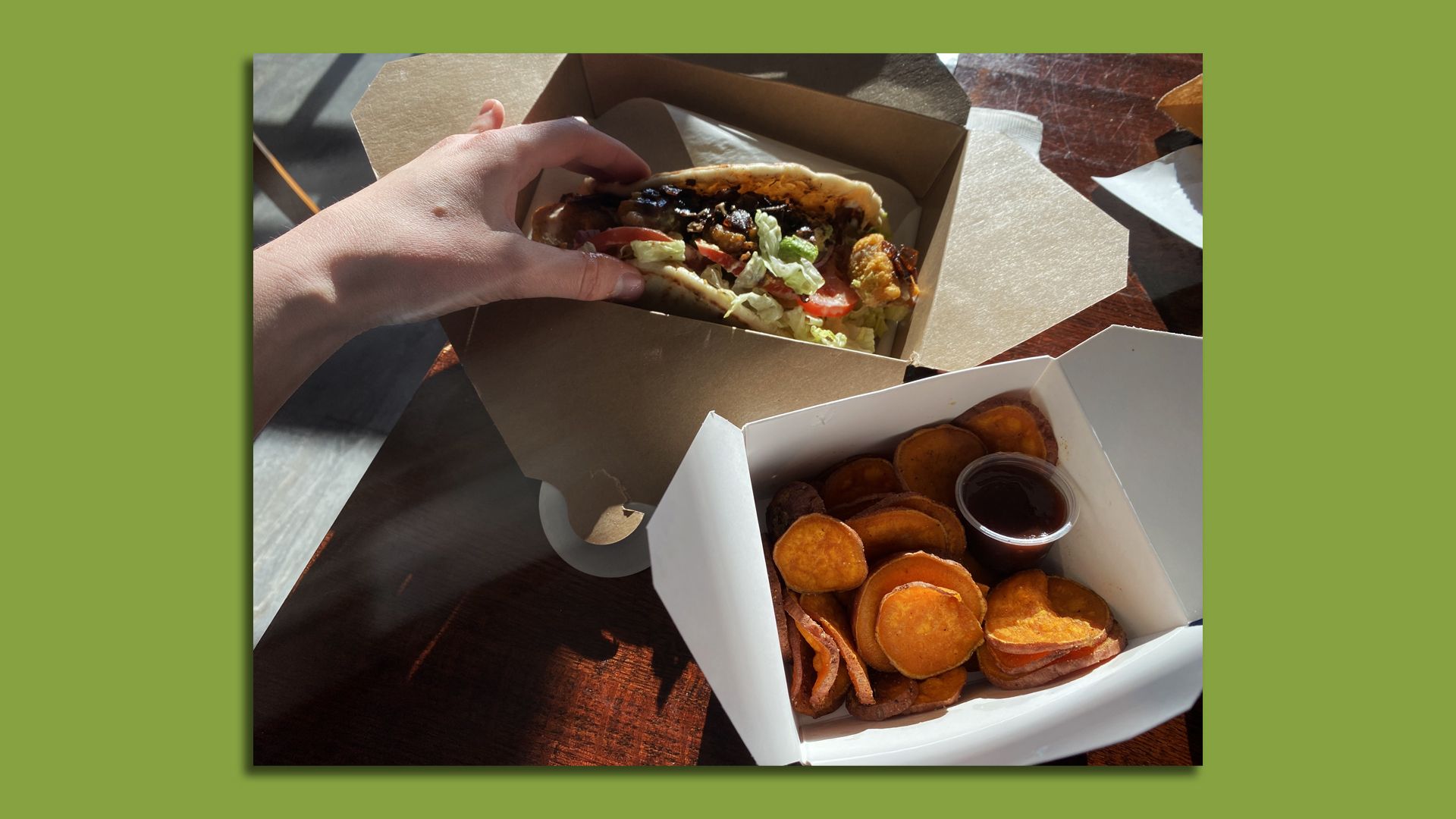 A stuffed wrap and bright orange yam fries.