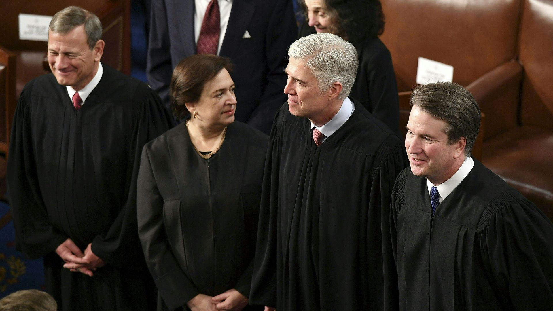 In this image, the Supreme Court justices stand in a line