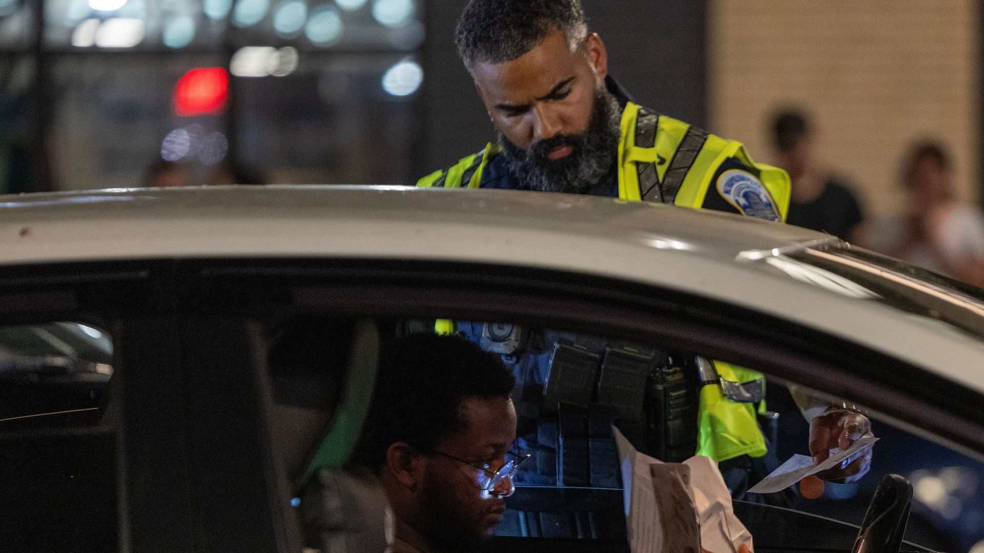 A police officer conducts a traffic stop.