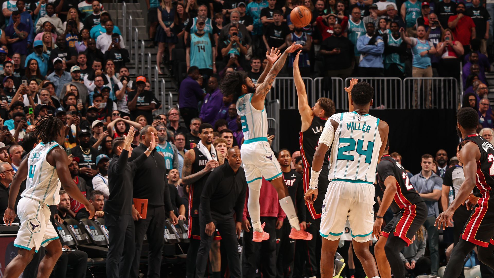 Coby White #3 of the Charlotte Hornets shoots the game tying three-point basket against the Miami Heat during the 2026 SoFi Play-In Tournament on April 14, 2026 at Spectrum Center in Charlotte, North Carolina.
