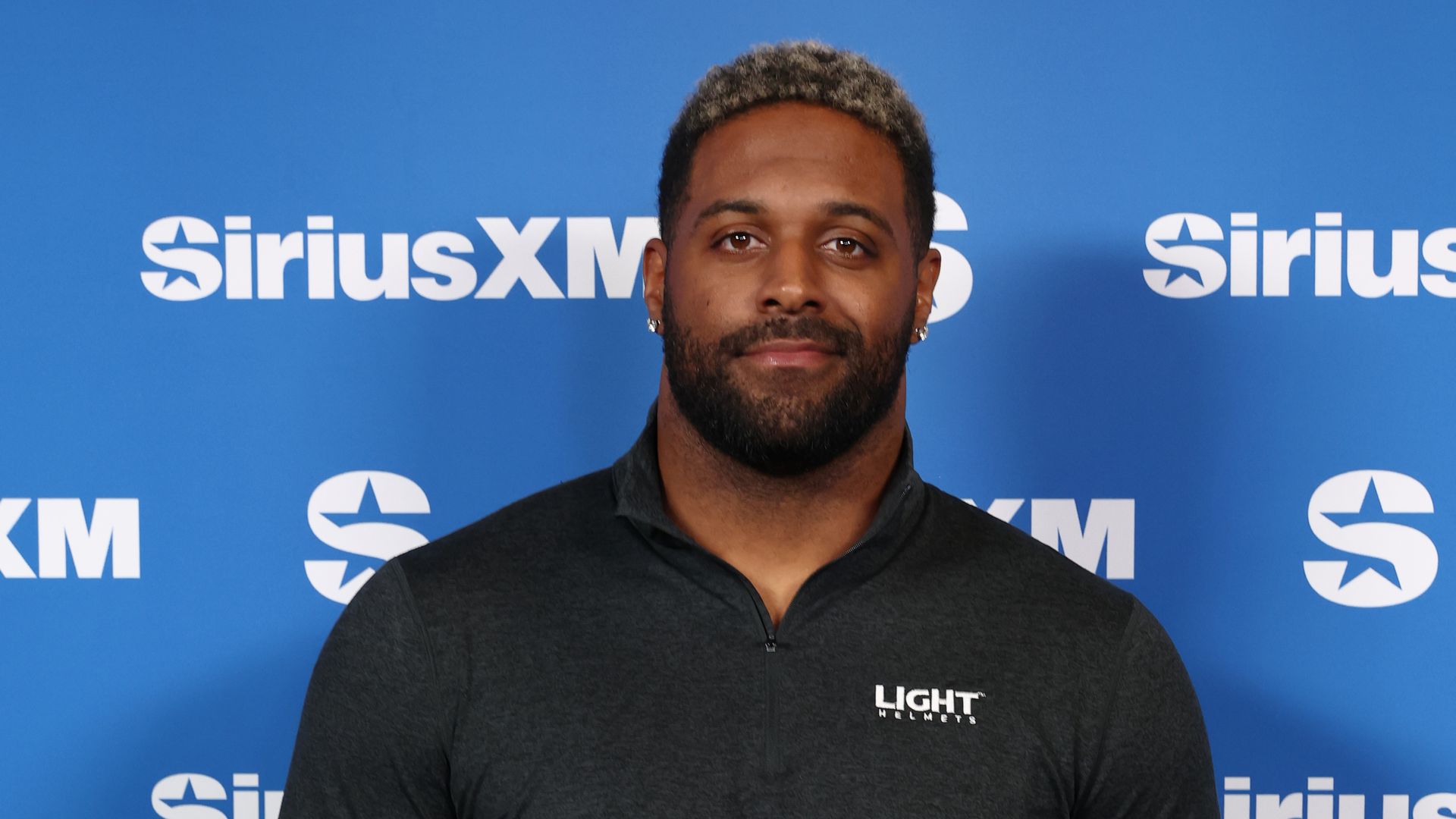 Image shows a headshot of Cam Jordan against a blue background.