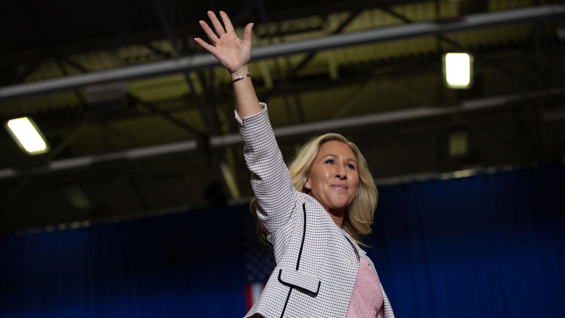 Rep. Majorie Taylor Greene (R-GA) waves to the crowd before she makes speaks during a Save America rally on October 1, 2022 in Warren, Michigan.