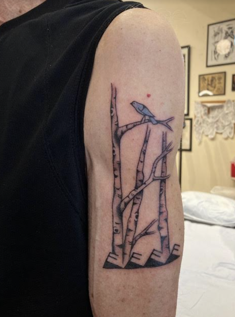 Tattoo of a bird on branches