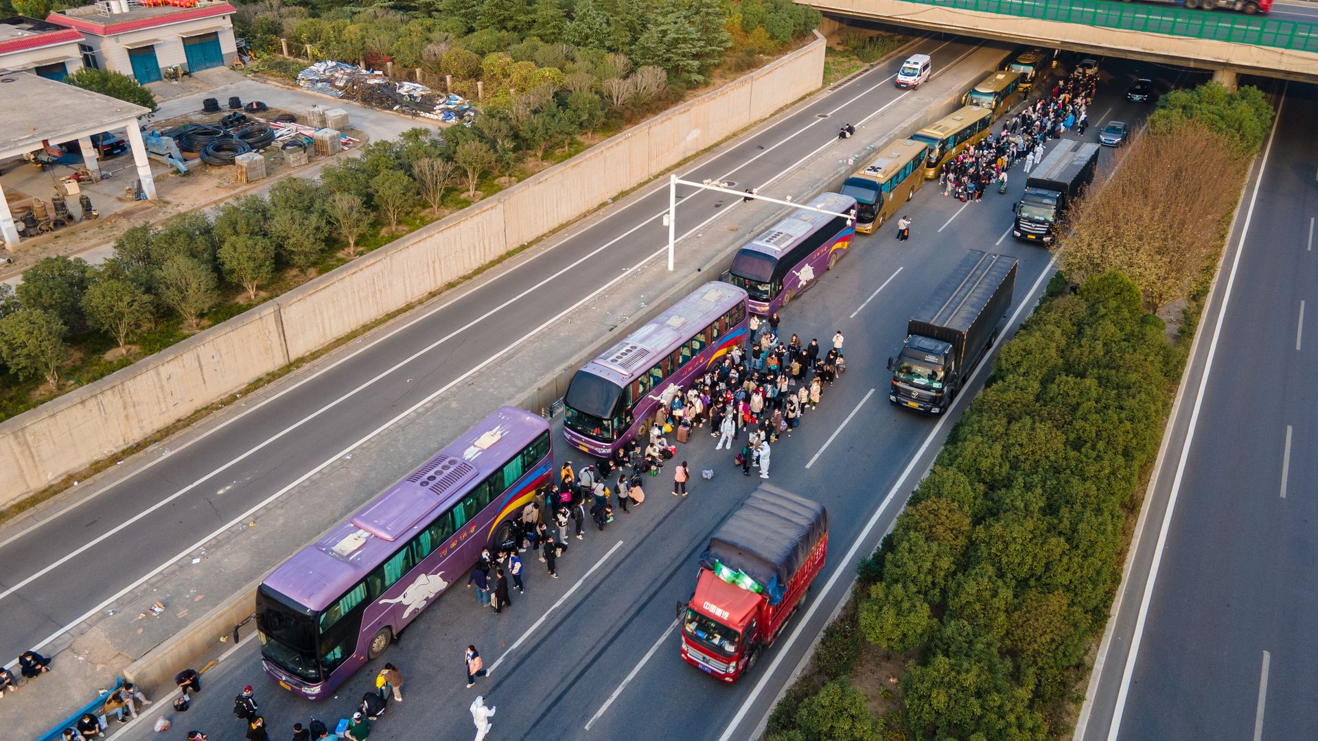 Foxconn employees take shuttle buses to head home on October 30, 2022 in Zhengzhou, Henan Province of China