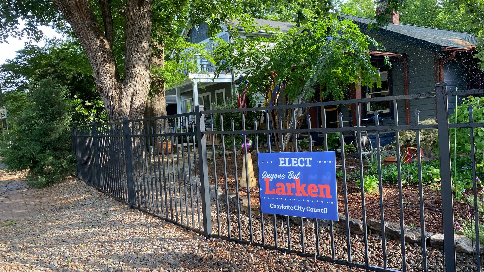 Sign in front of a house that says "elect anyone but Larken"