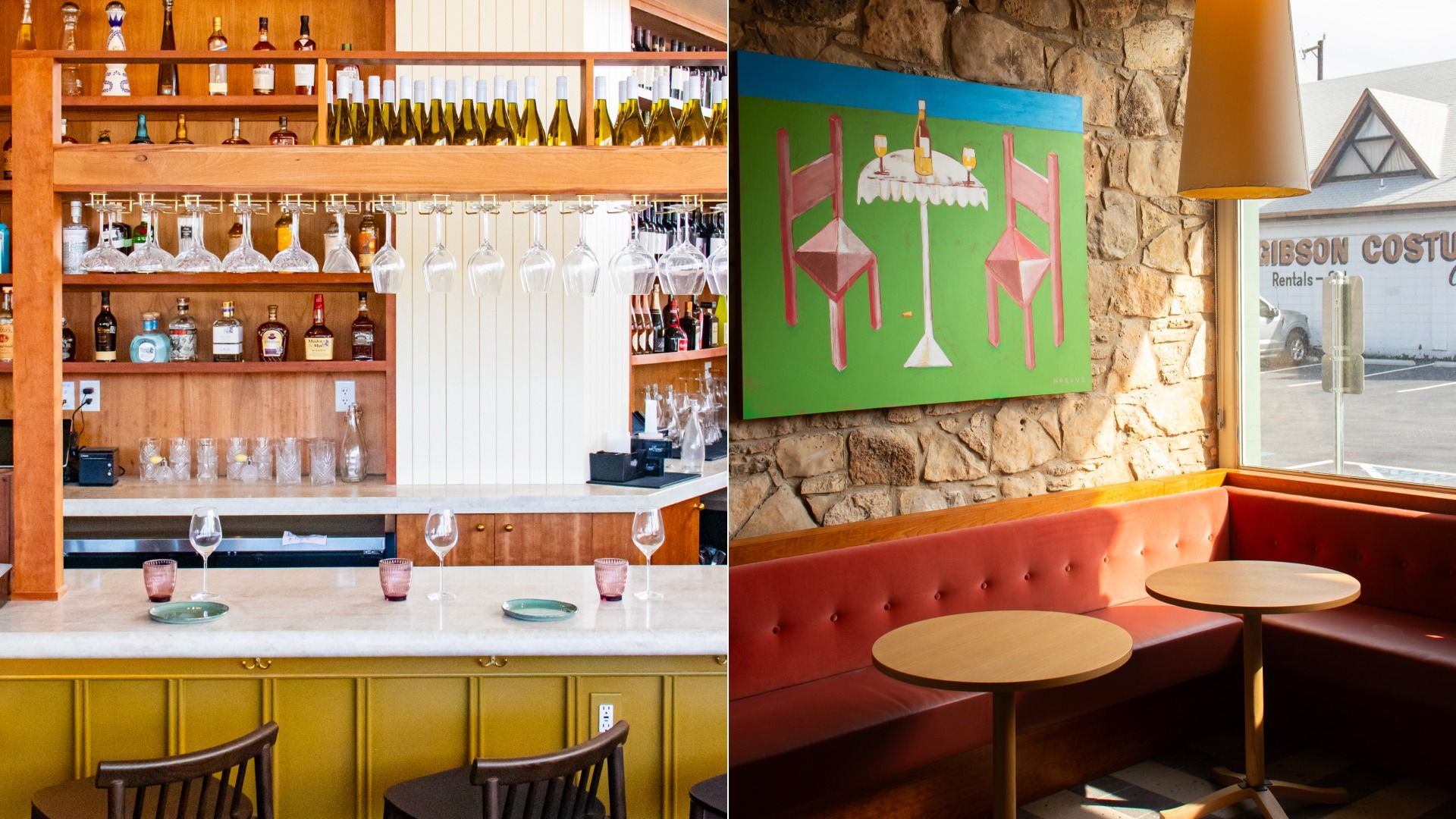 Interior of a bar and lounge area with wooden shelves holding bottles and hanging glasses, a yellow bar with stools, a red cushioned booth, round wooden tables, stone wall, and a window showing a street view.