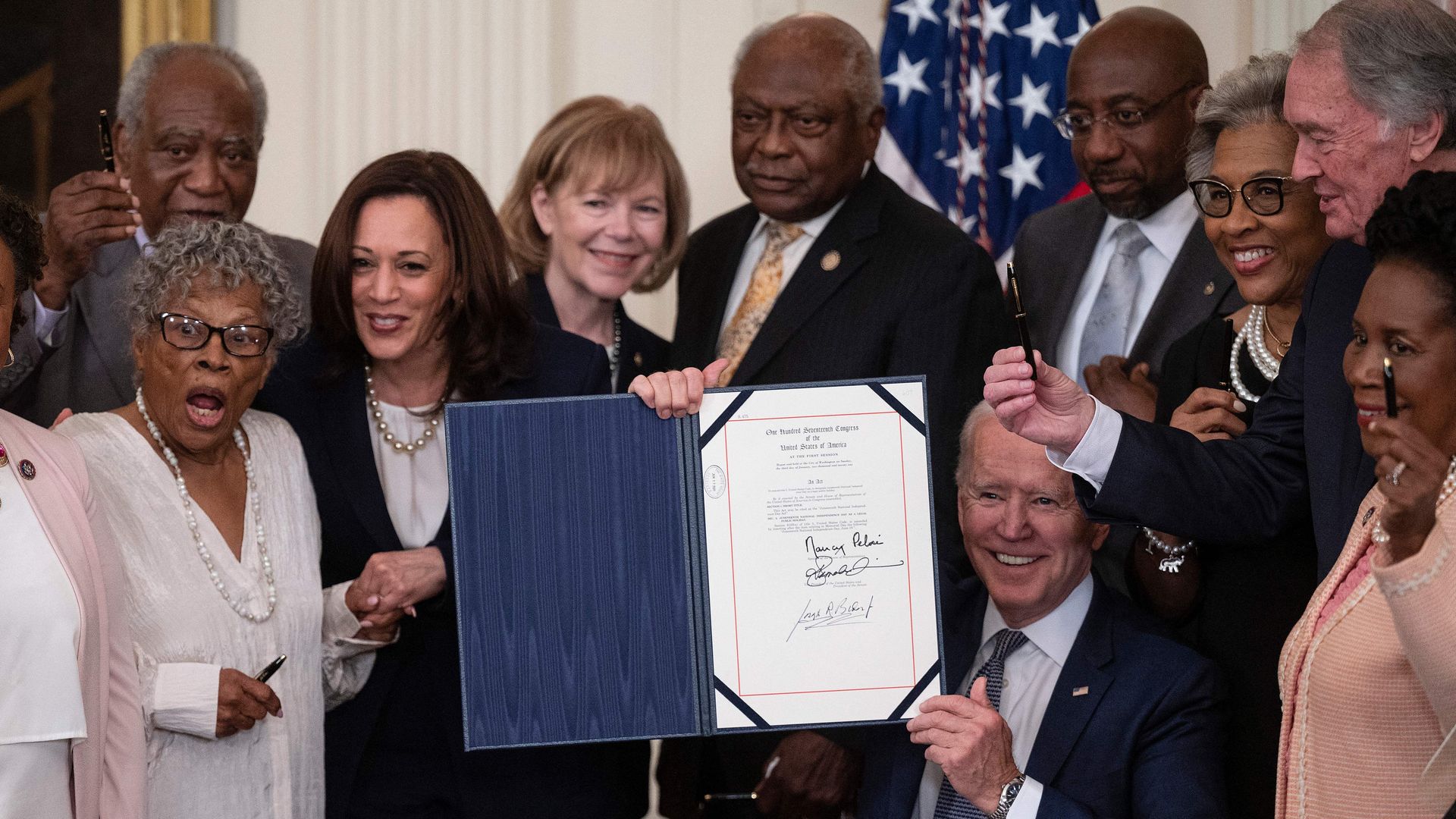 President Biden and Vice President Harris with members of Congress after the signing in the White House on June 17.