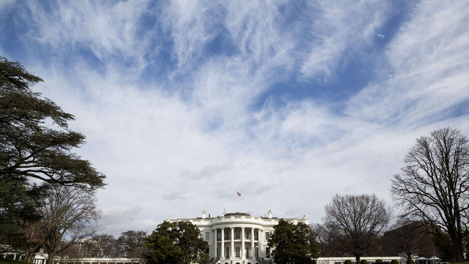A wide shot of the White House from the south