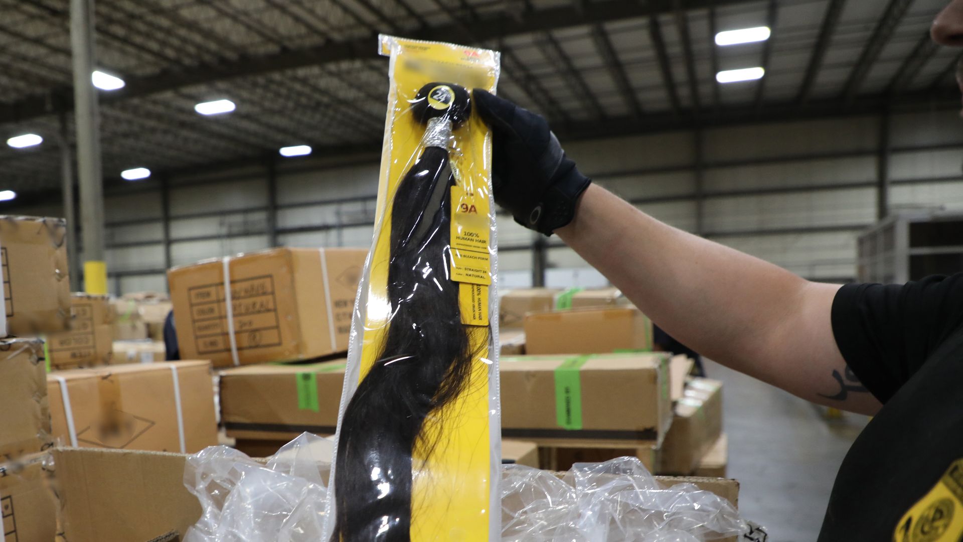 A CBP agent holds up product made form human hair