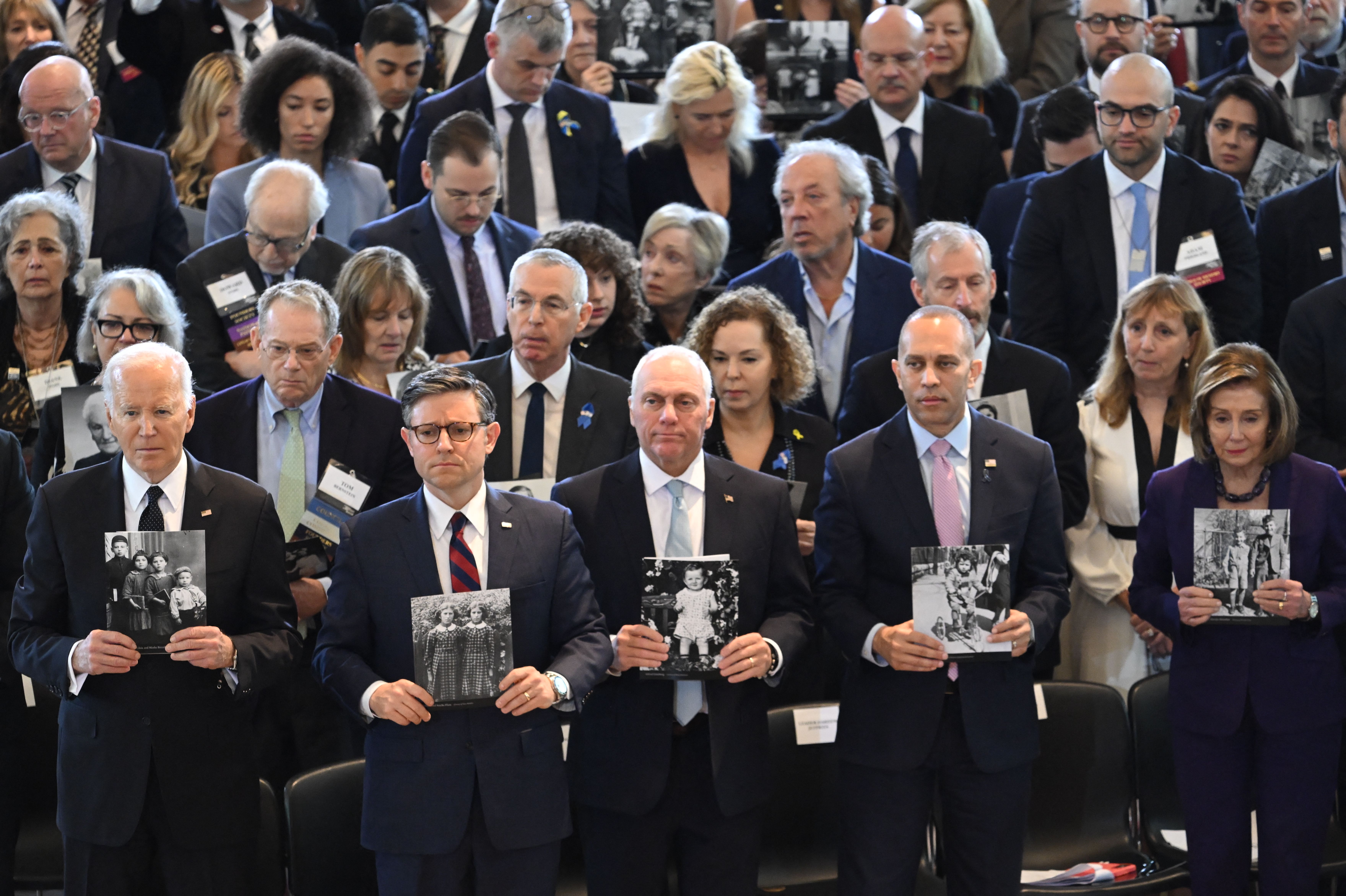 President Joe Biden, House Speaker Mike Johnson, House Majority Leader Steve Scalise, House Minority Leader Hakeem Jeffries and former House Speaker Nancy Pelosi hold images of Holocaust victims during the annual Days of Remembrance ceremony for Holocaust survivors at the US Capitol