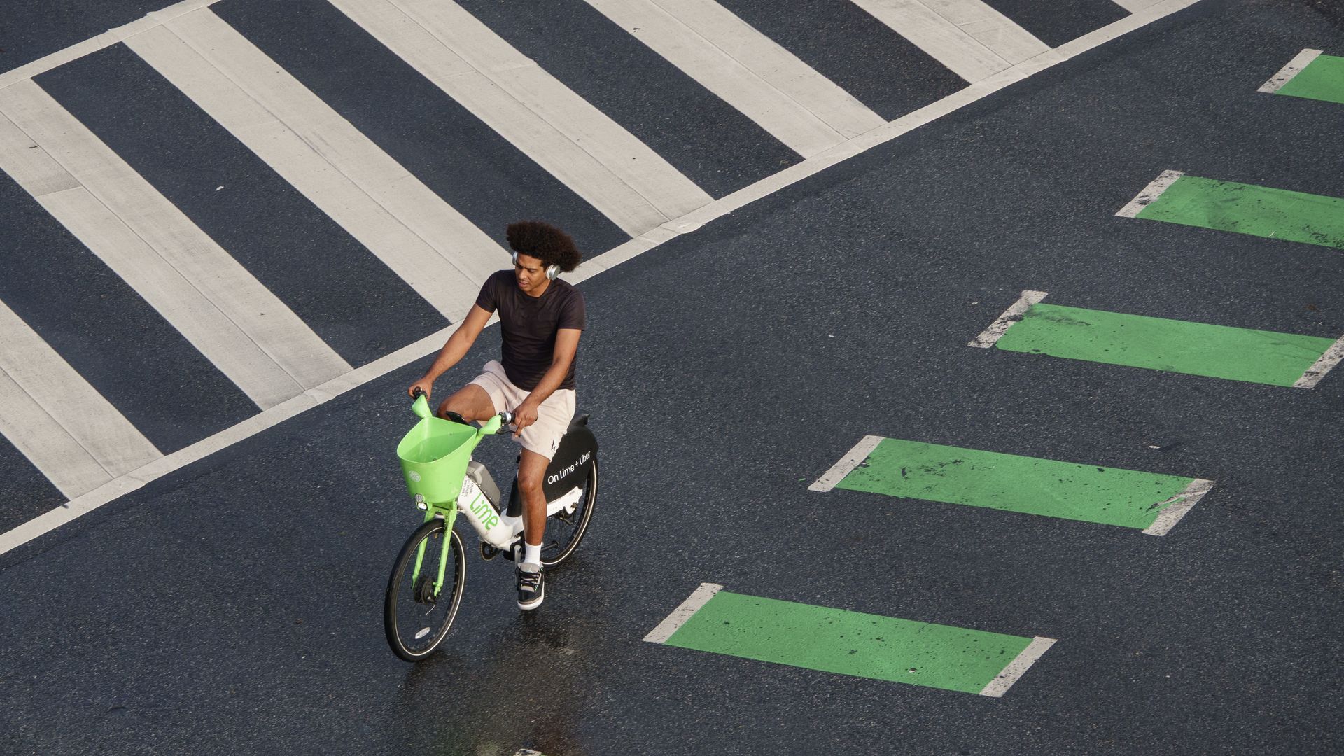 WASHINGTON, DC - JUNE 18: A man rides a Lime electric bicycle along a bike lane on June 18, 2025 in Washington, DC.(Photo by Kevin Carter/Getty Images)