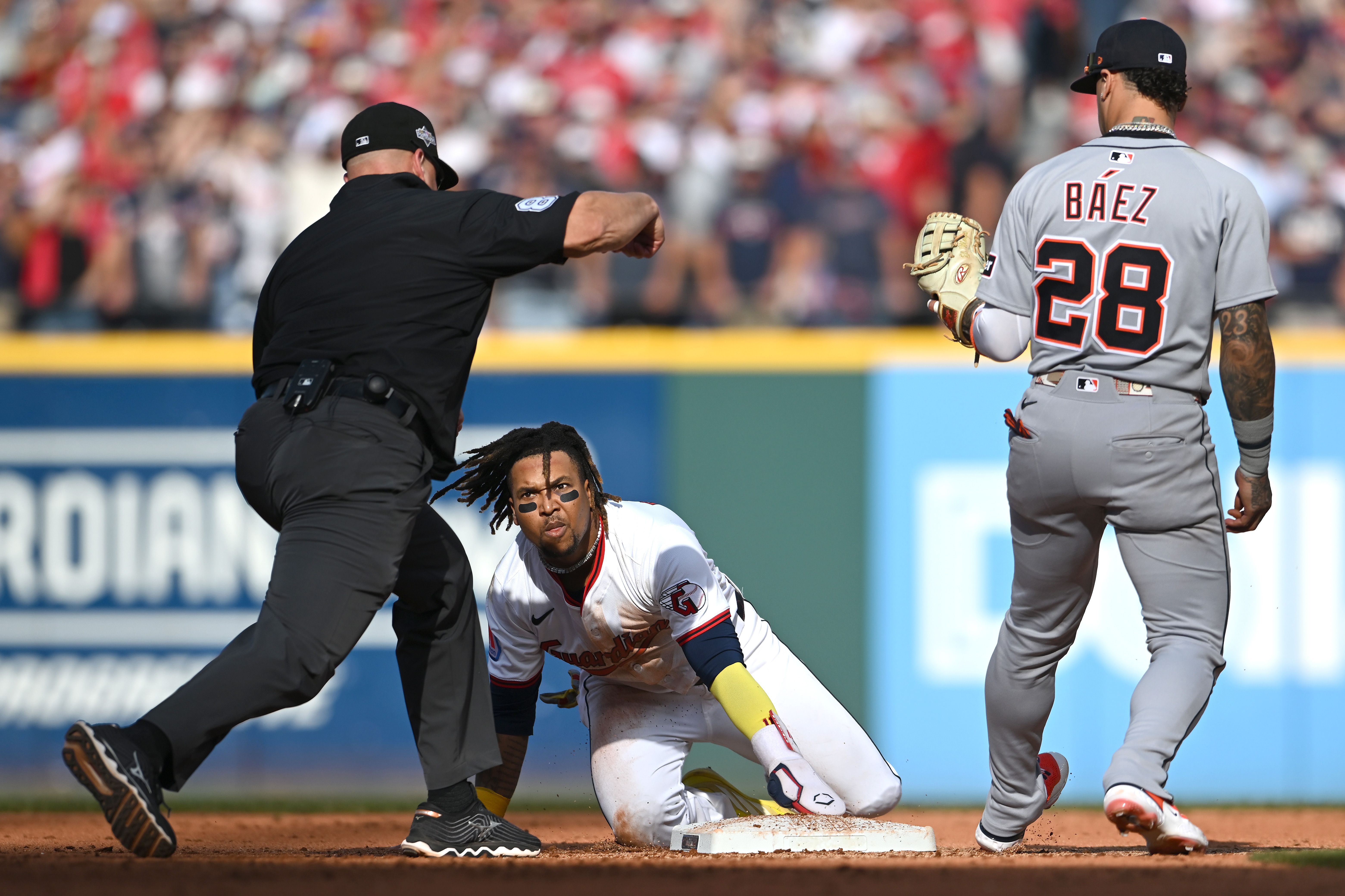 José Ramírez #11 of the Cleveland Guardians reacts after being caught stealing by Javier Báez #28 of the Detroit Tigers.
