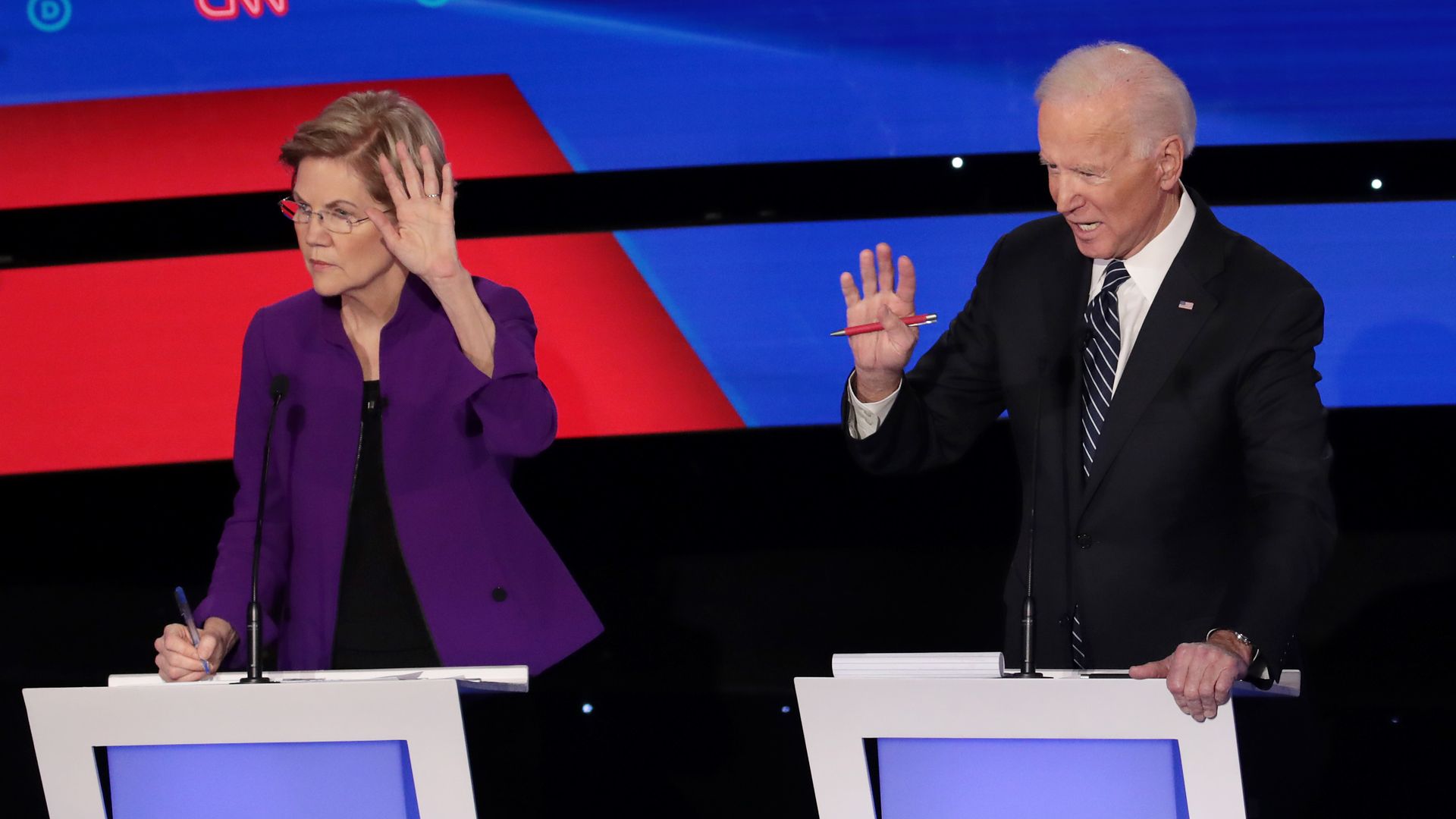 This image shows Elizabeth Warren and Joe Biden standing on the debate stage.