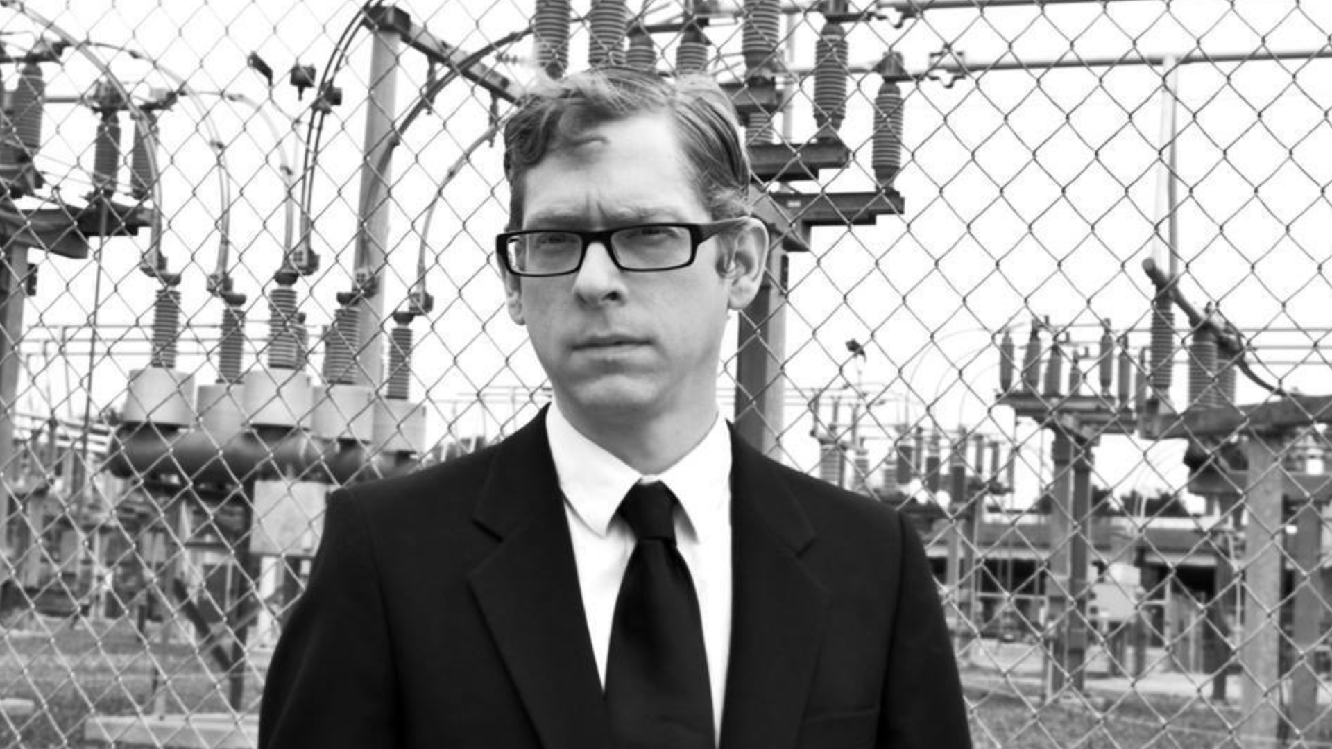 A black-and-white headshot of Josh Hitchens