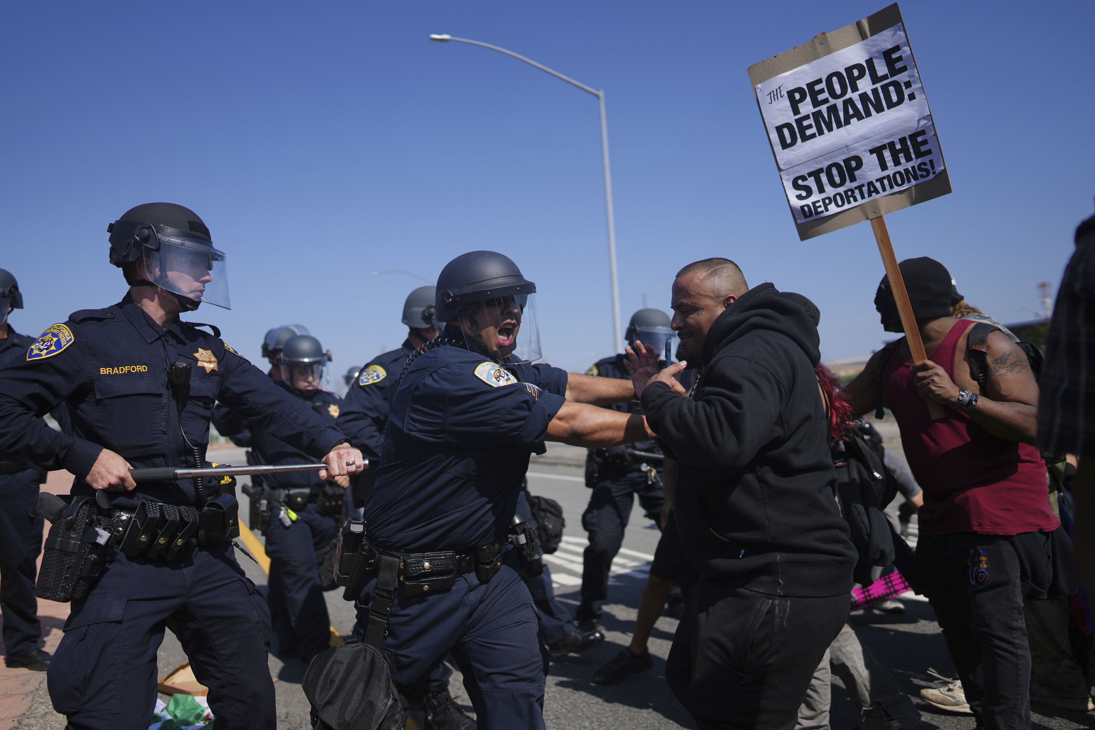 California Highway Patrol officers clash with protesters in Los Angeles yesterday.