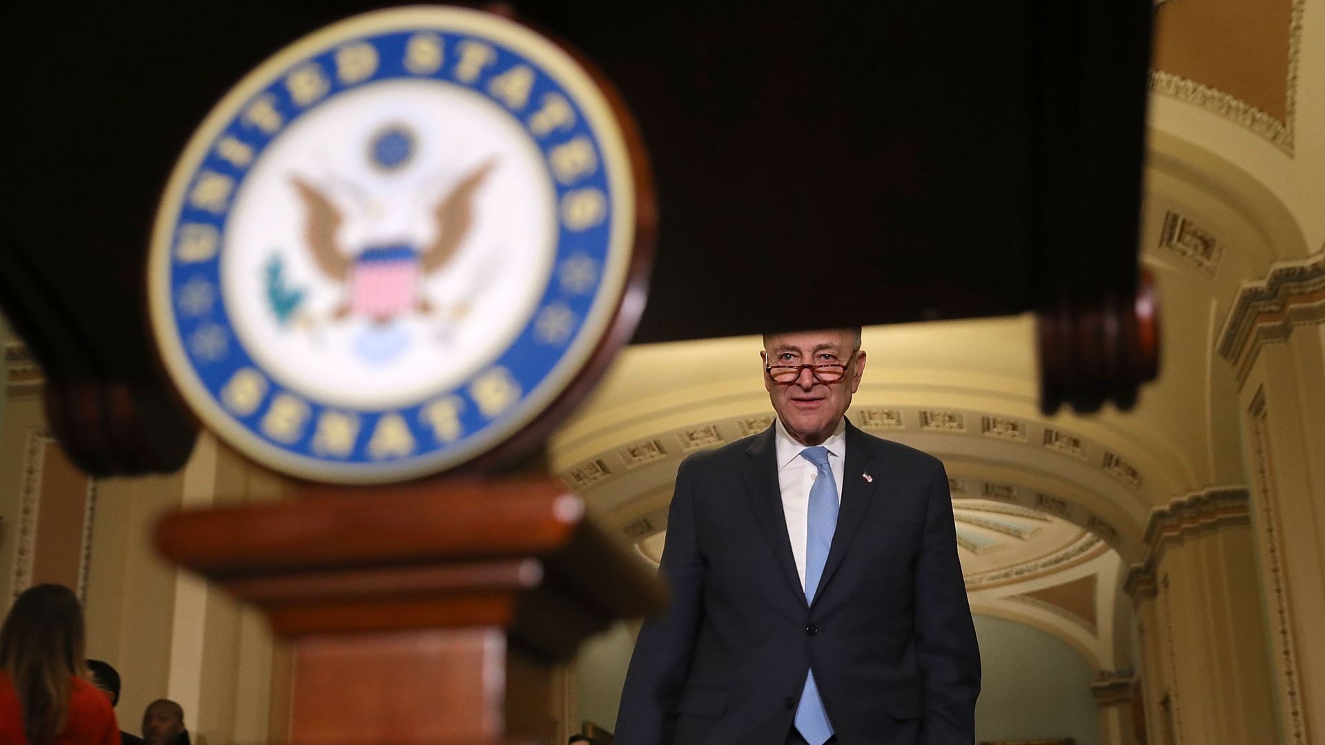 Chuck Schumer walks to a Senate podium