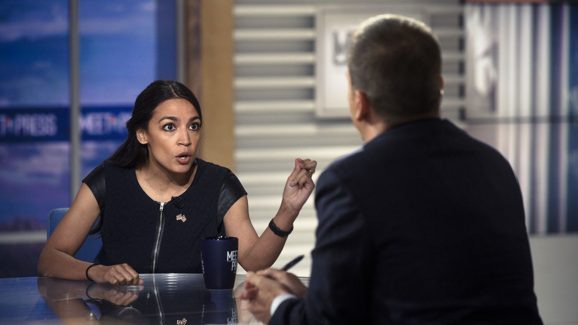Alexandria Ocasio-Cortez gestures to Chuck Todd on Meet the Press