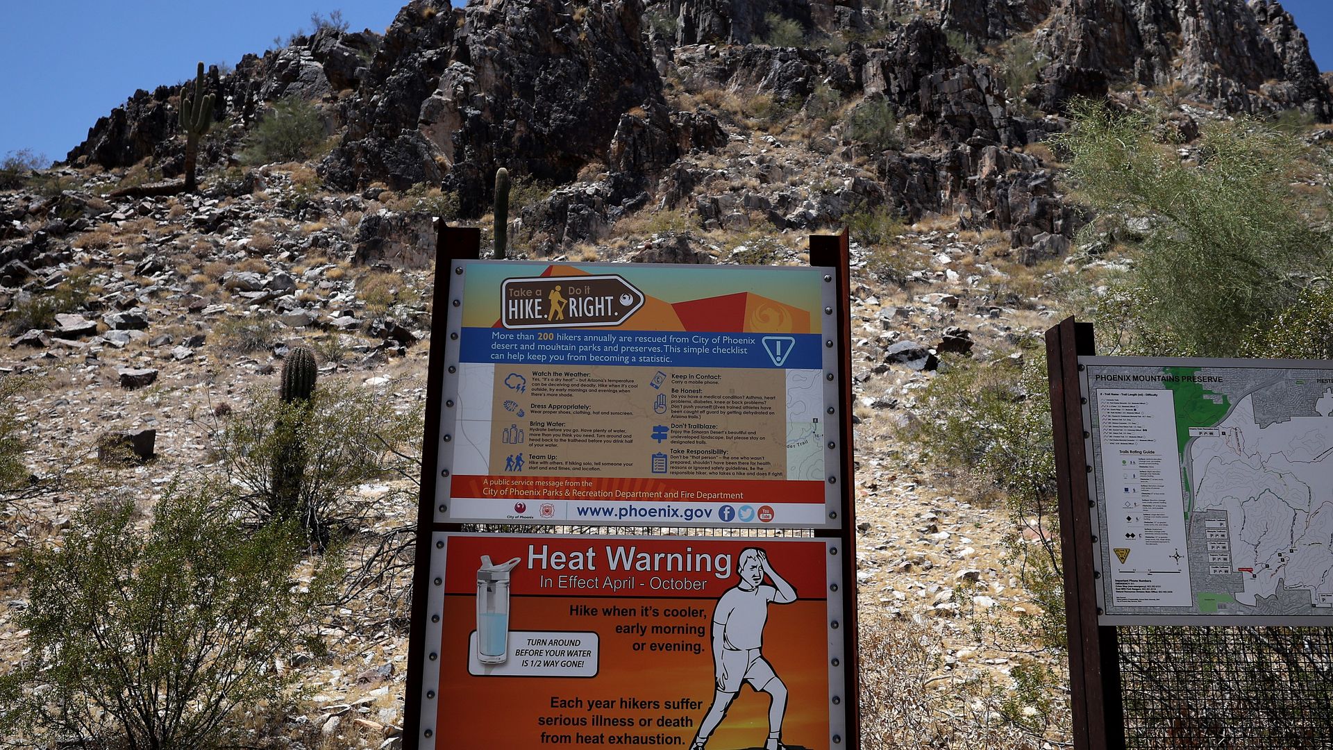 A heat warning sign in front of a mountain. 