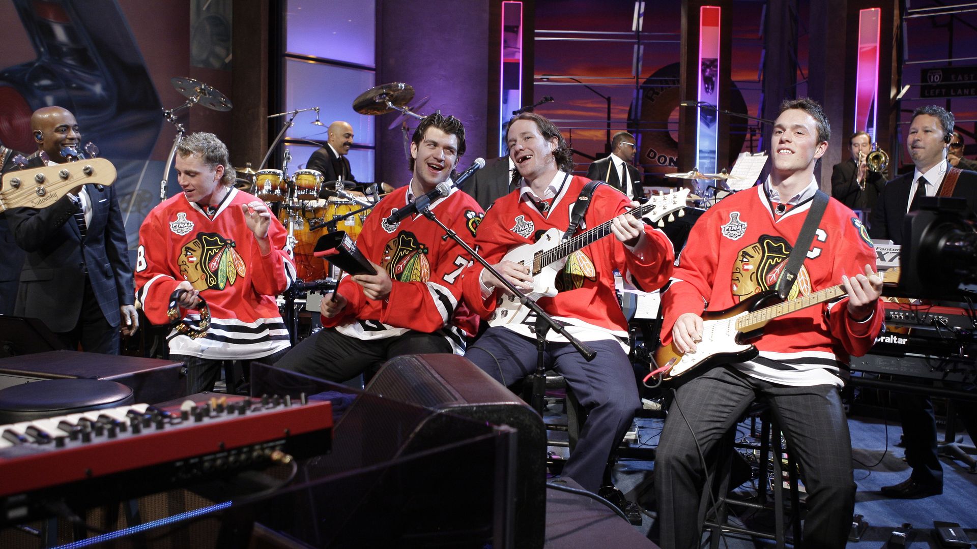 Photo of hockey players playing in a band on a TV show. 