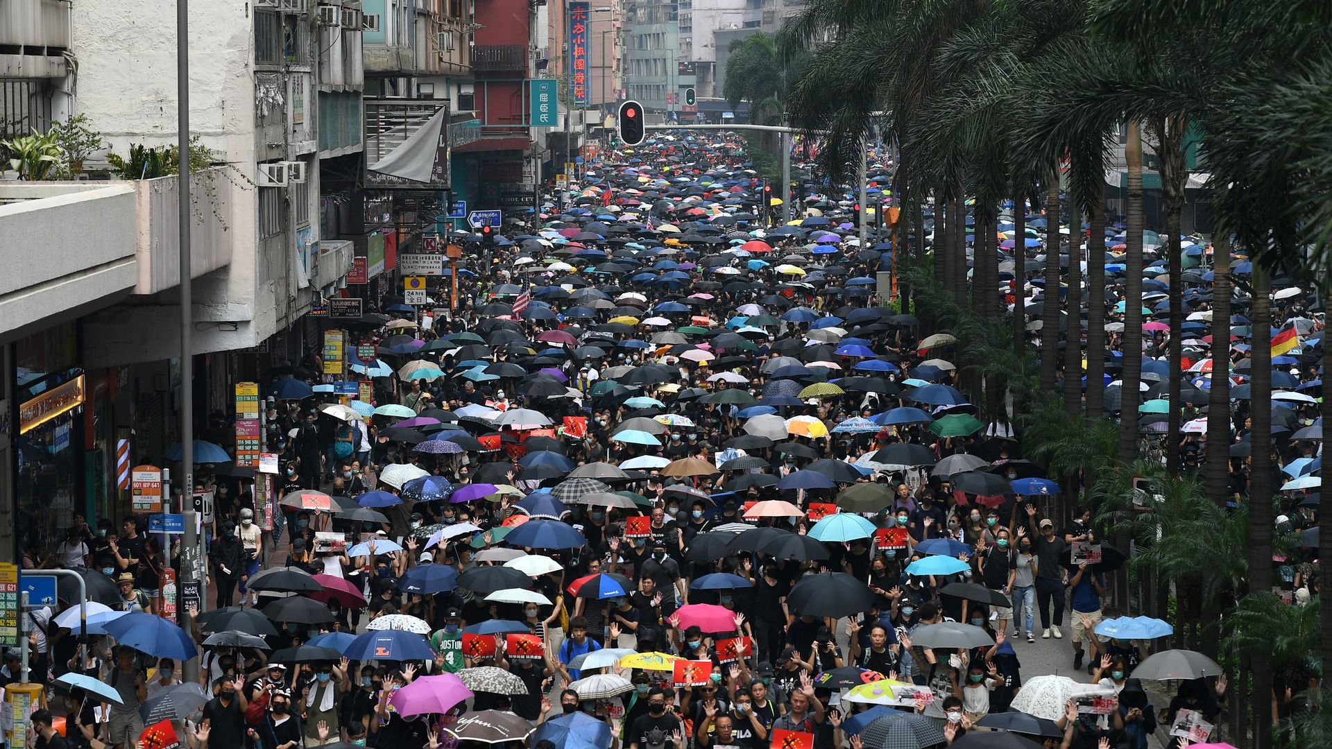 Thousands of people hold an unsanctioned march through the streets of Hong Kong