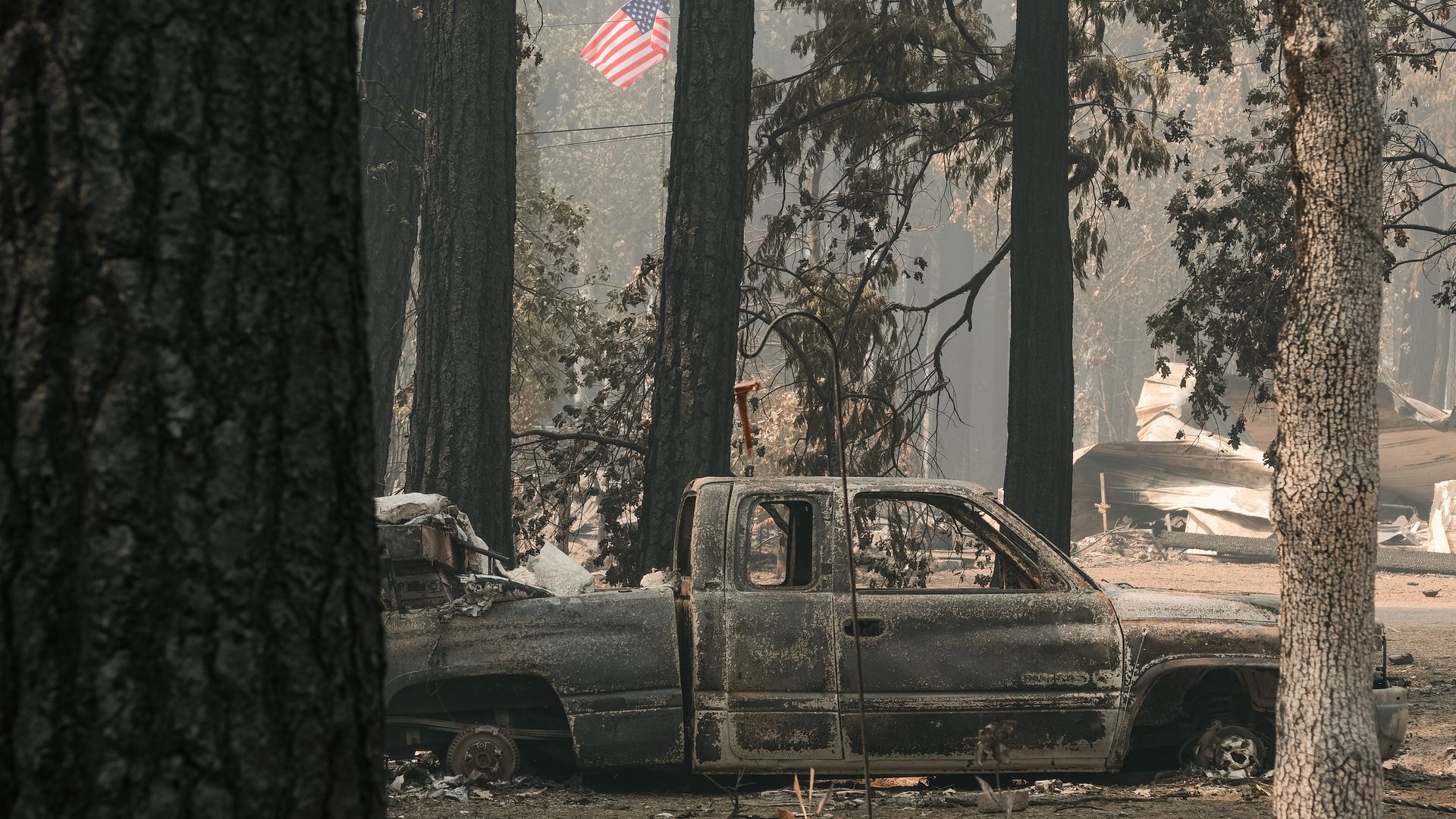 A burned vehicle sits among destroyed structures caused by the Dixie Fire on August 9, 2021 situated near Highway 89 in Indian Falls, California.