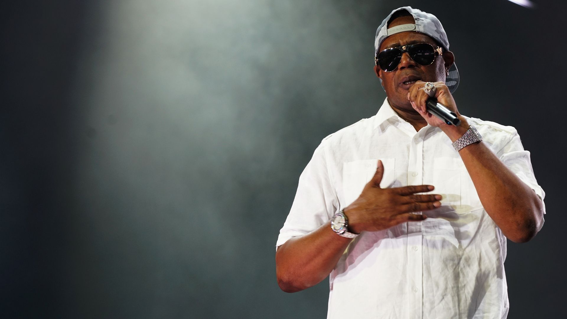 Master P speaks into a microphone.