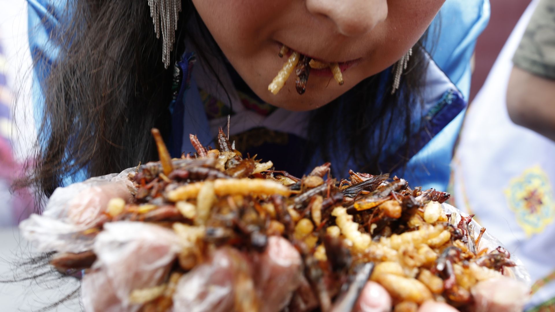 A woman eats insects in Yunnan, China