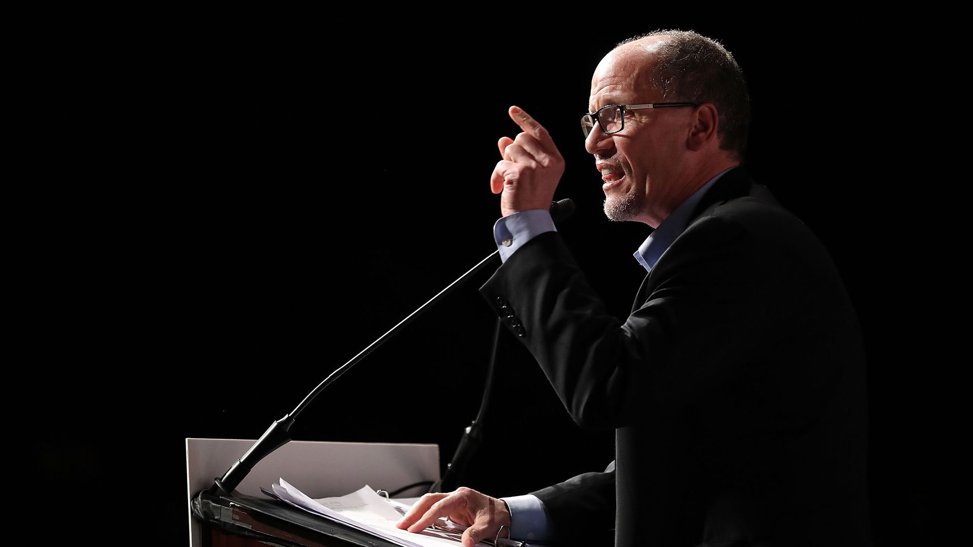 Tom Perez speaking at a podium.