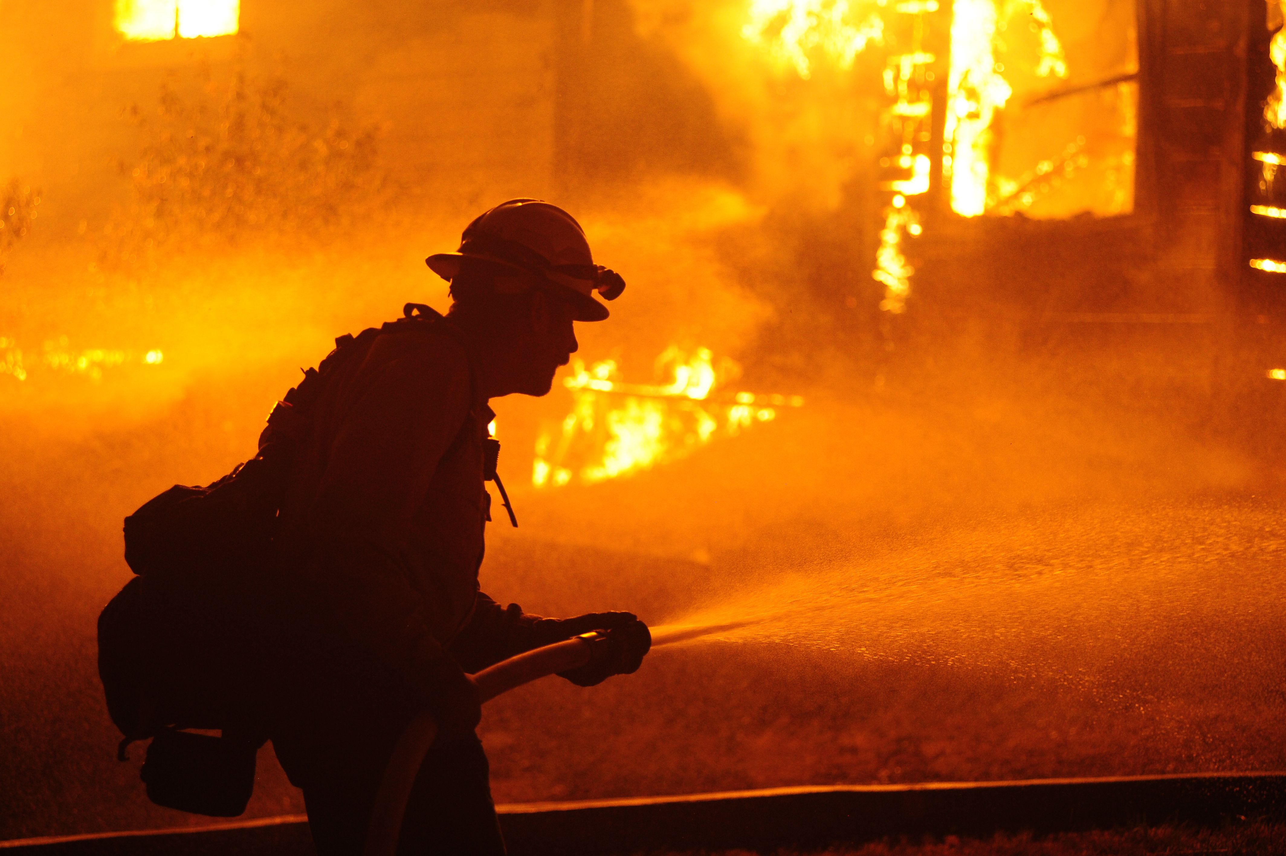Firefighters try to extinguish Dixie Fire near Chico in Greenville, California, United States on August 5, 2021.