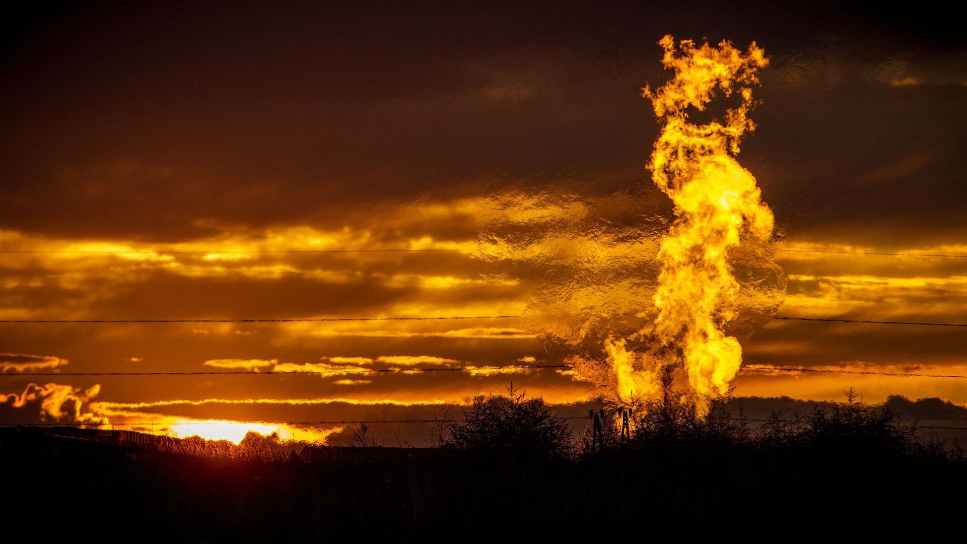 Photo of Flames from a flaring pit near a well in the Bakken Oil Field in North Dakota