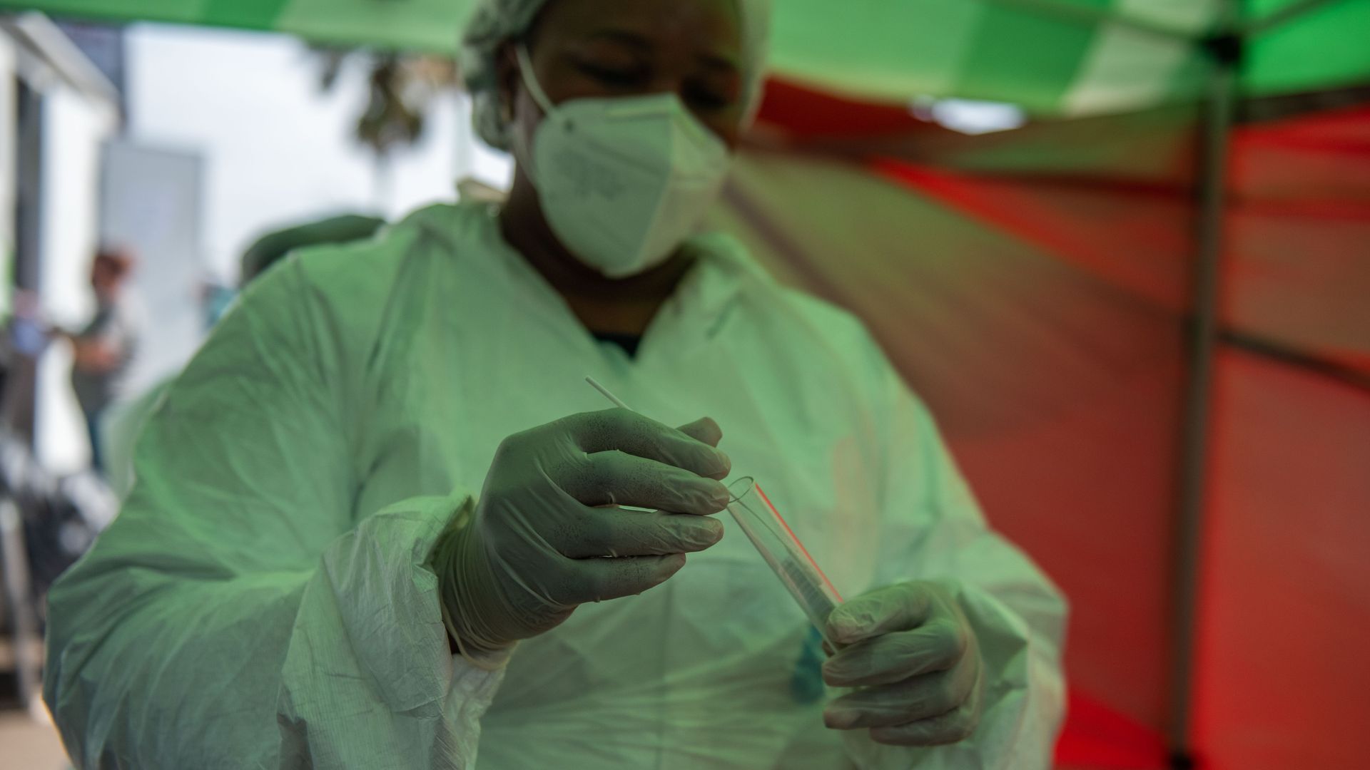 A doctor holds a COVID-19 test.