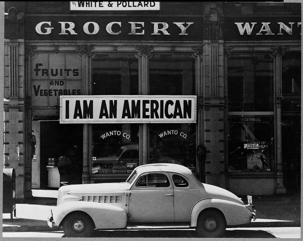 "I am an American" sign in a shop window.
