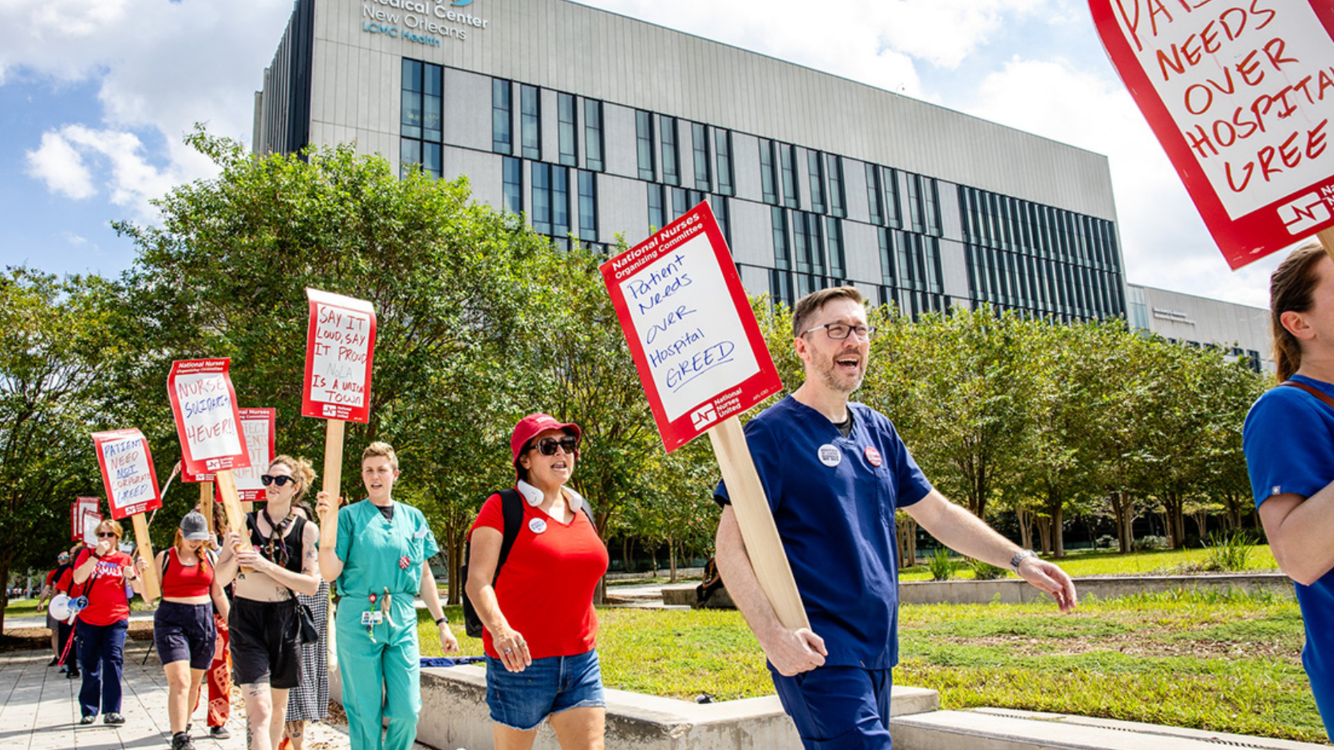 Images show people with signs protesting outside UMC.