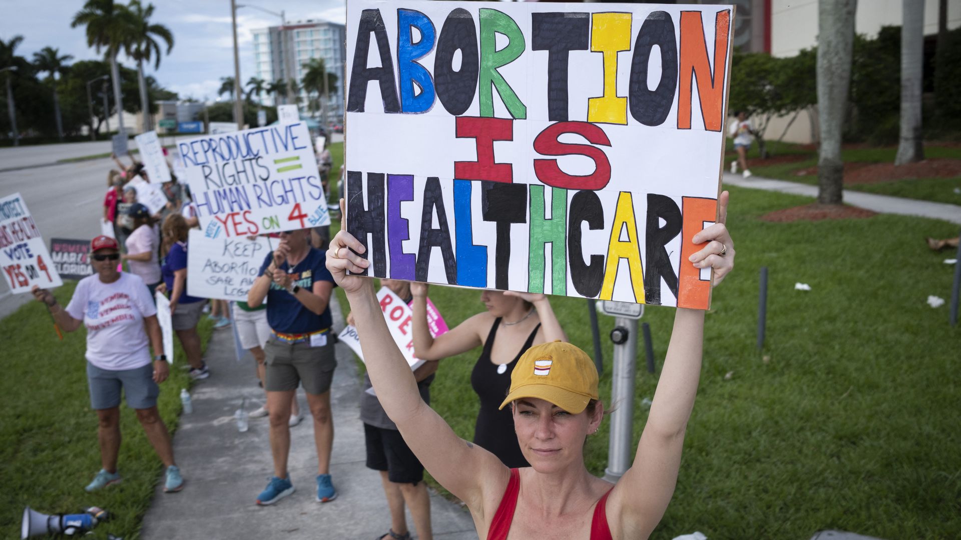 People hold up signs during a pro-abortion rights rally on the second anniversary of the Supreme Court ruling to overturn Roe v. Wade, in West Palm Beach, Florida, on June 24, 2024. 